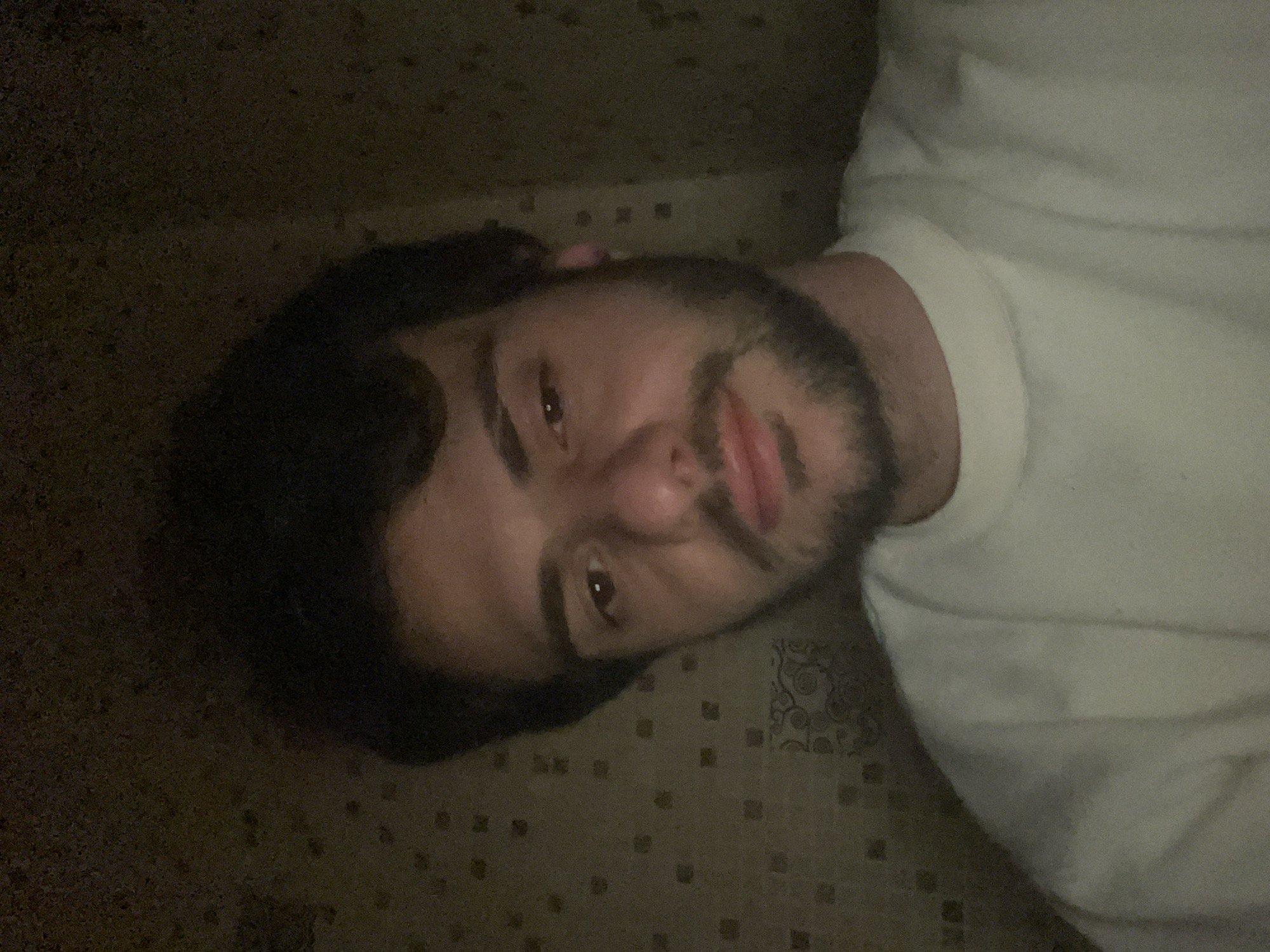 Man takes multiple selfies indoors in Tbilisi