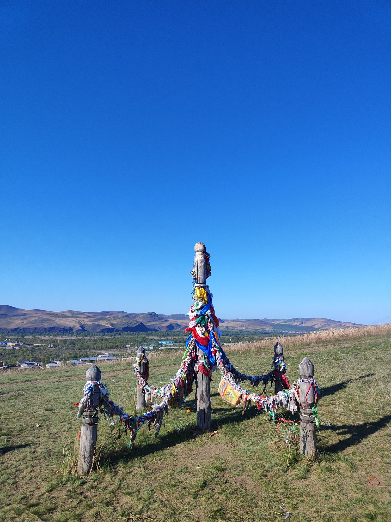 Witness documents decorated wooden posts and stone cairns in countryside