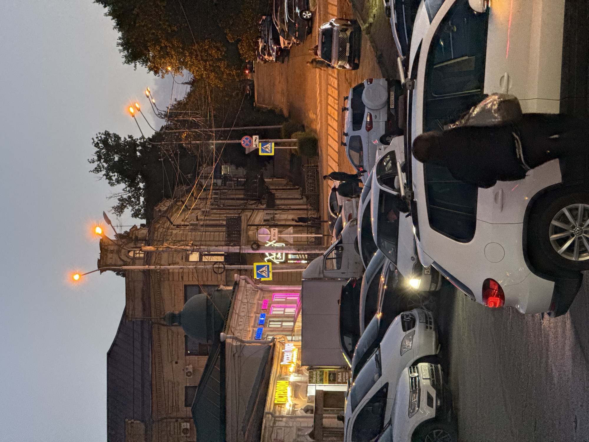 Stavropol commercial district at dusk, storefronts and street life