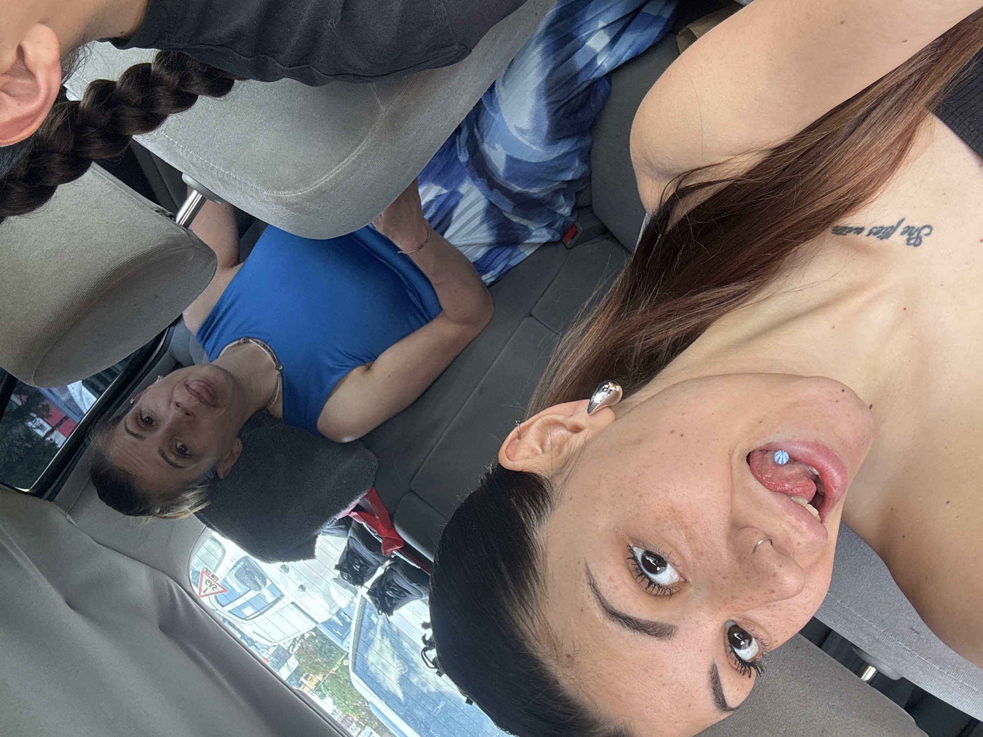 Young woman takes selfie in car with friends in Sofia