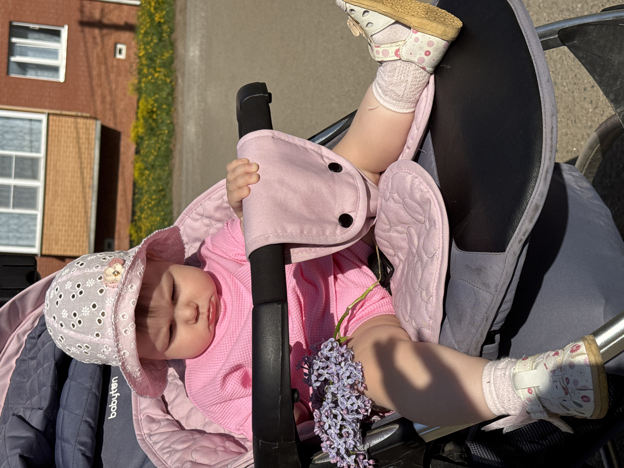 Baby enjoys spring outing in stroller in Zav'yalovo