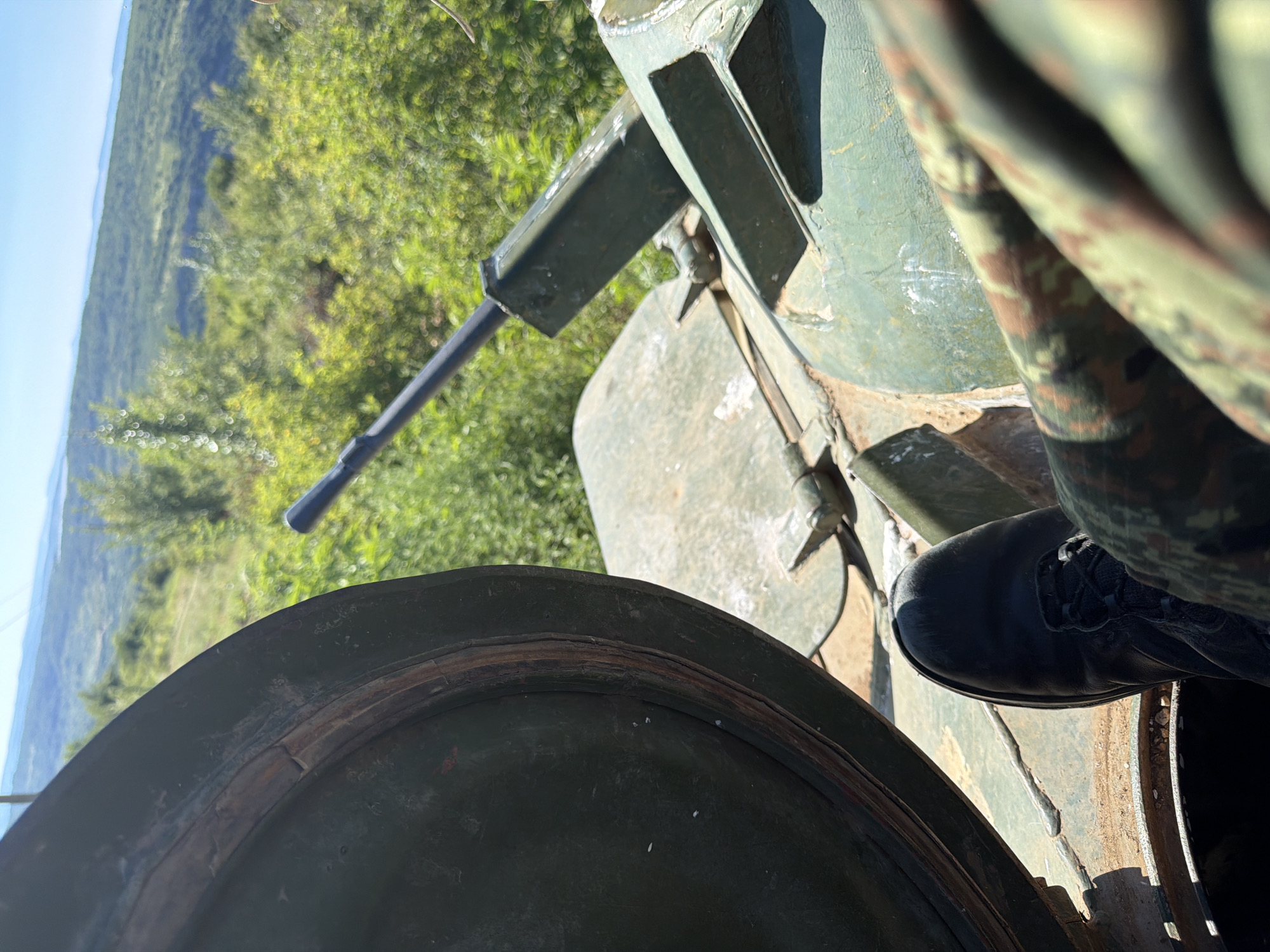 Tank and white smoke on hilly terrain in rural Bulgaria