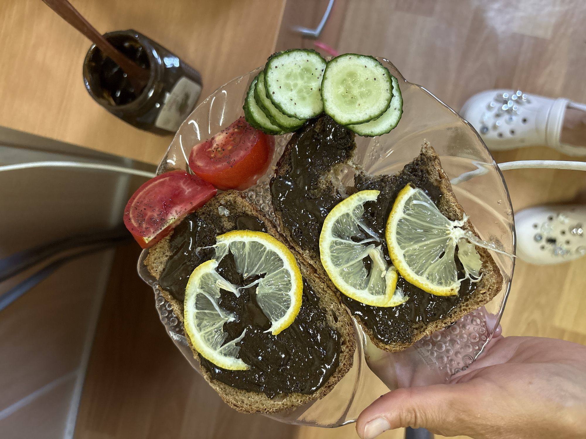 Dark bread with paste and fresh vegetables on a plate