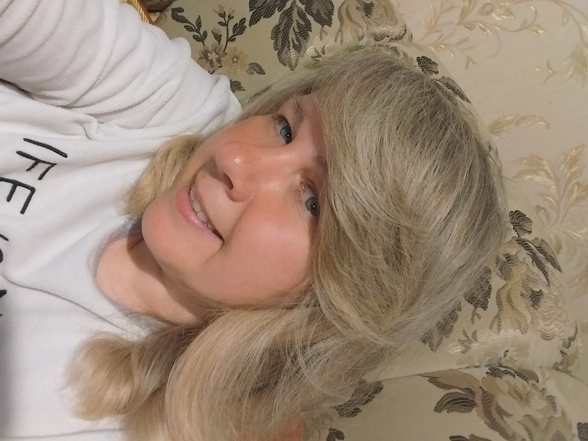 Woman captures relaxed selfies on couch in Orenburg
