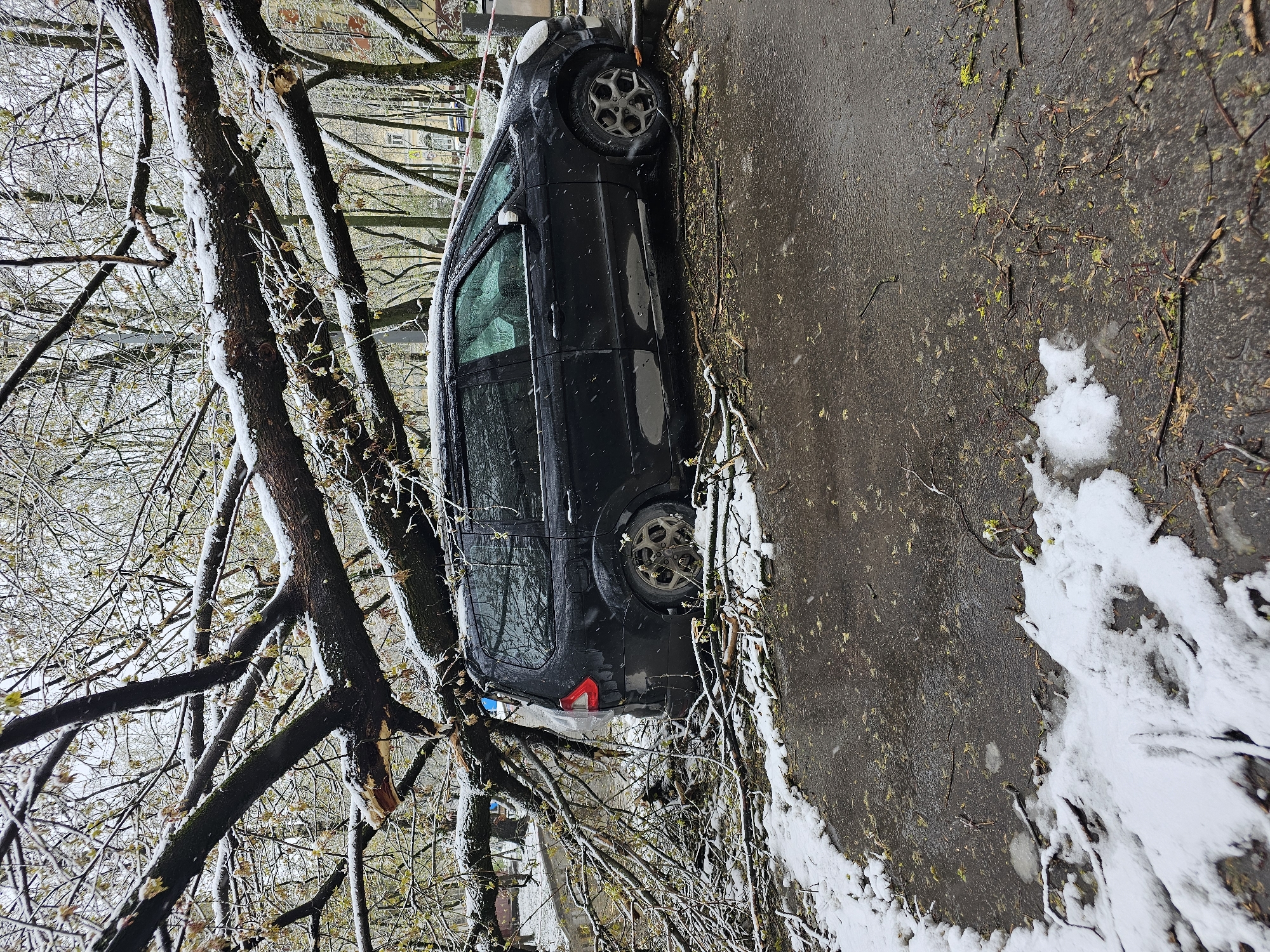 Car on wet pavement amid winter weather aftermath in Moscow
