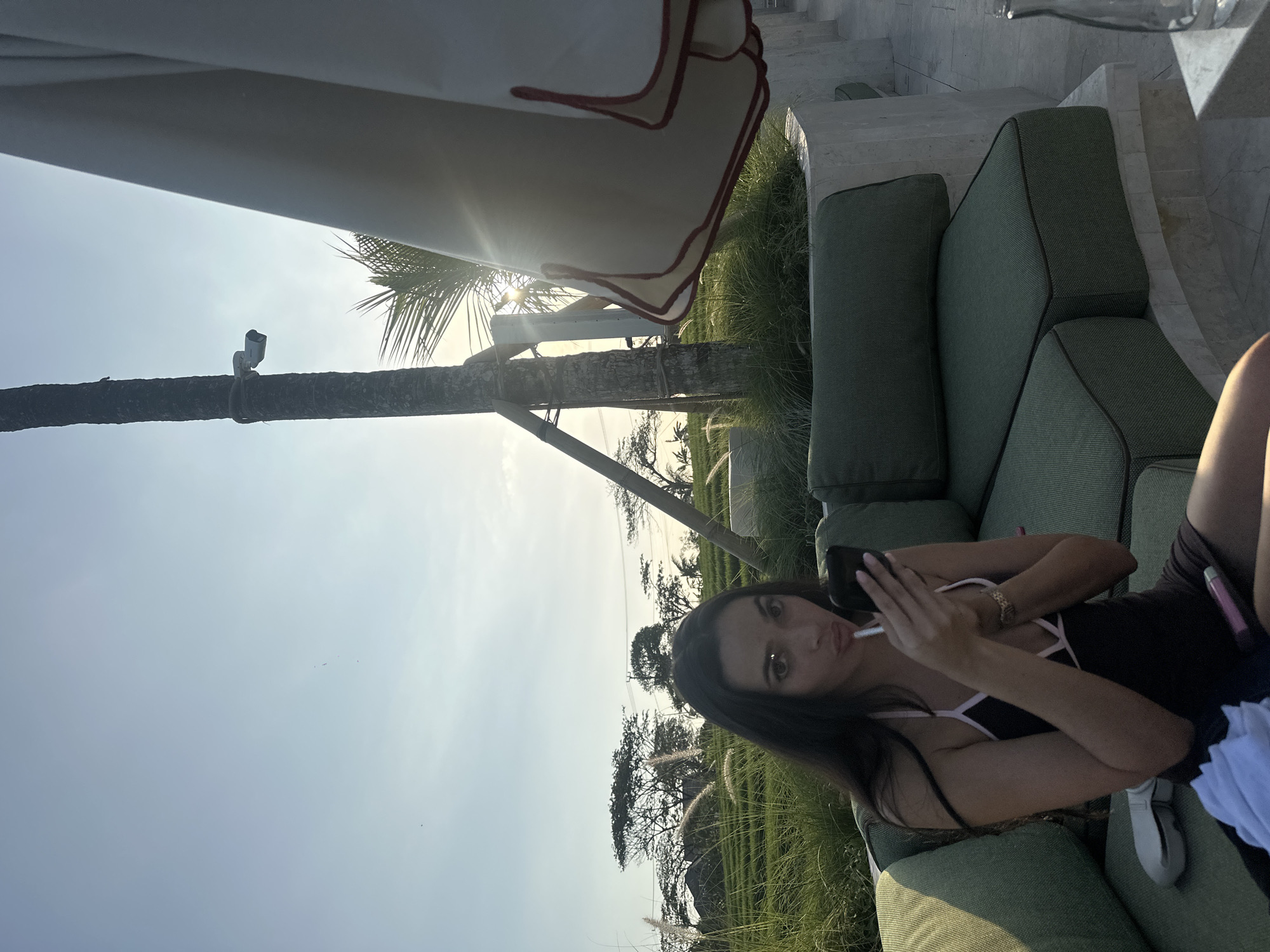 Lazy poolside afternoon at a resort, phone in hand