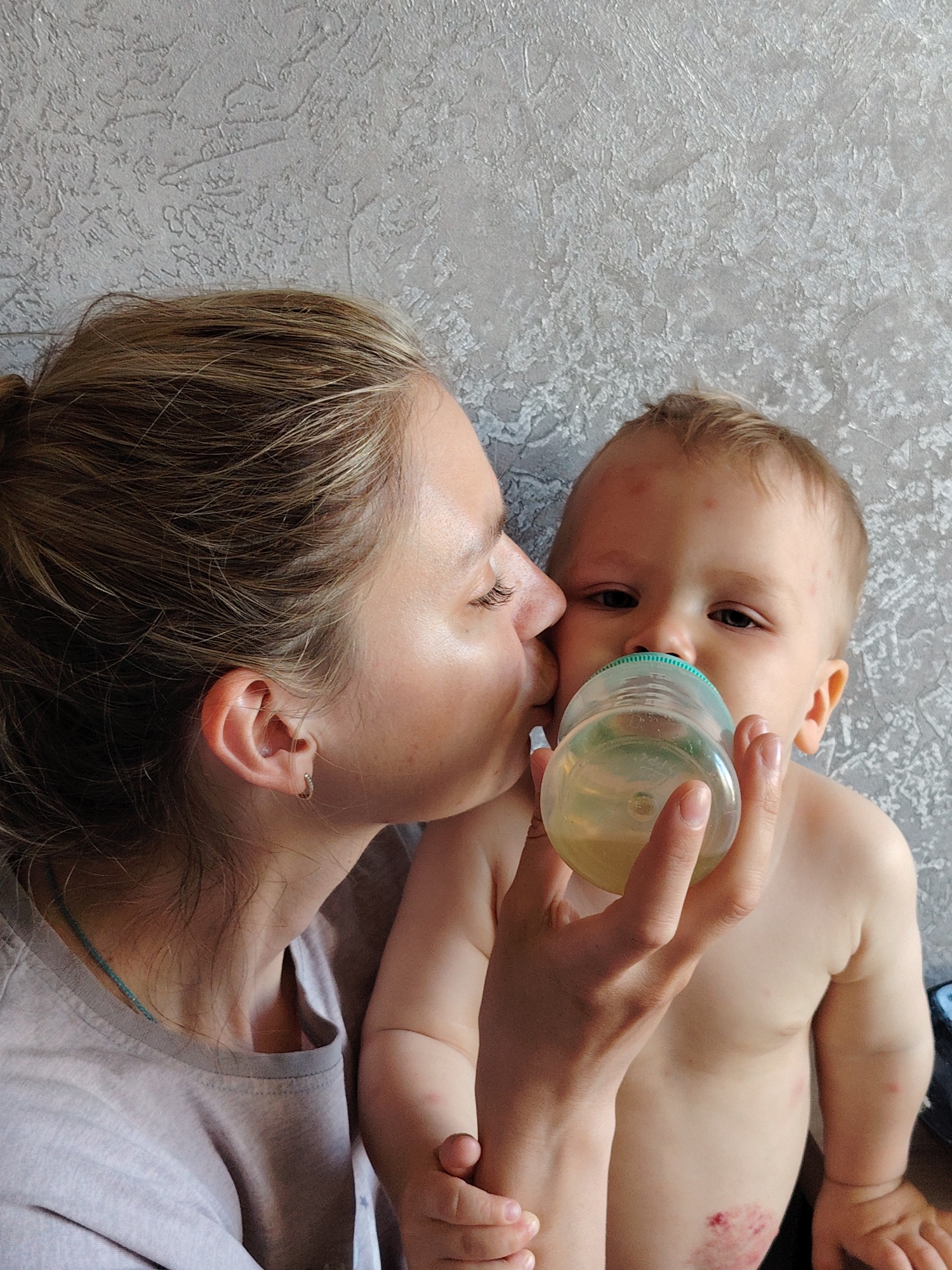 Family moments documented during baby's feeding time in Chaikovsky