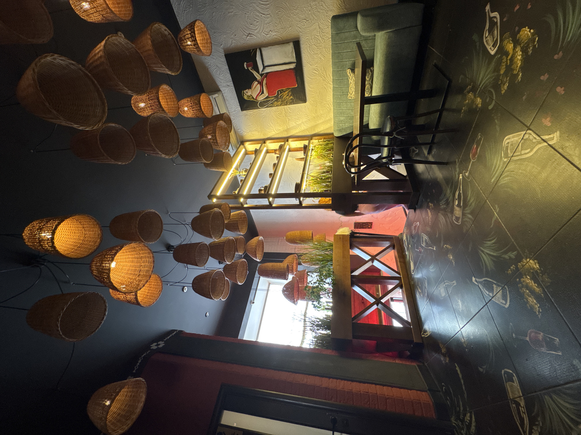 Rustic restaurant interior in Chernivtsi, lit by woven basket lamps