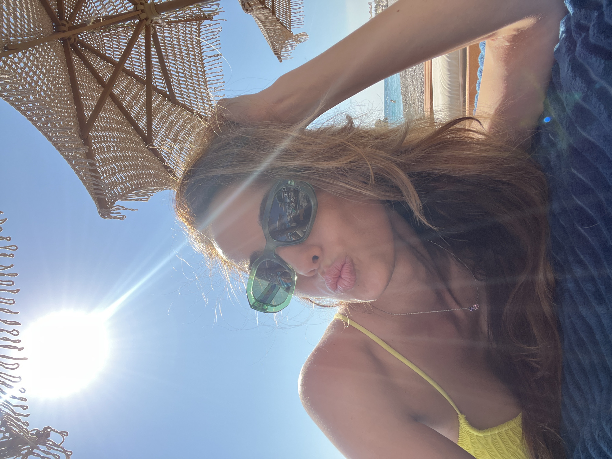 Woman sunbathes at Pečurice beach, Montenegro