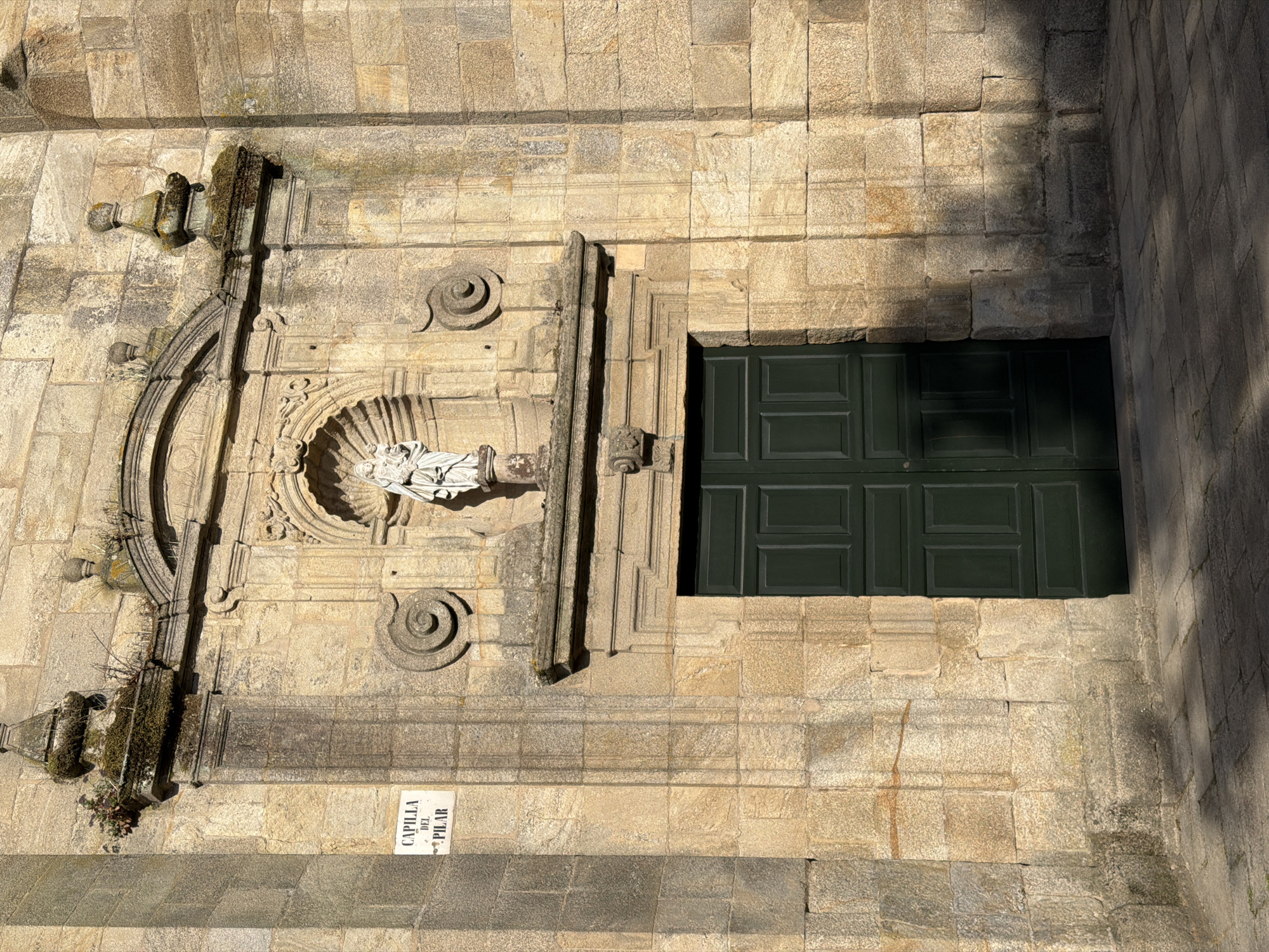 Walking the old stones outside a Santiago church