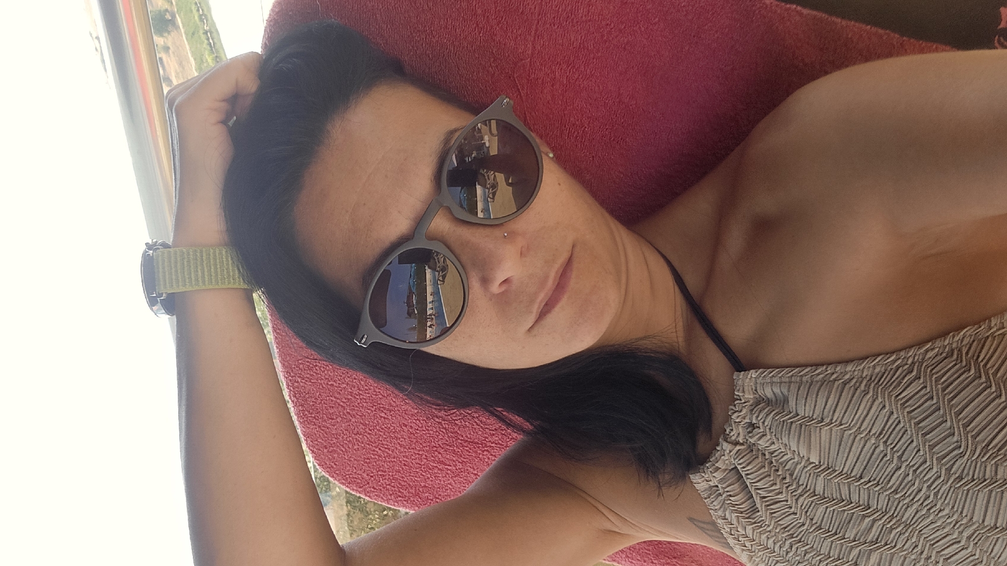 Poolside selfies on a red lounge chair, Breznik.