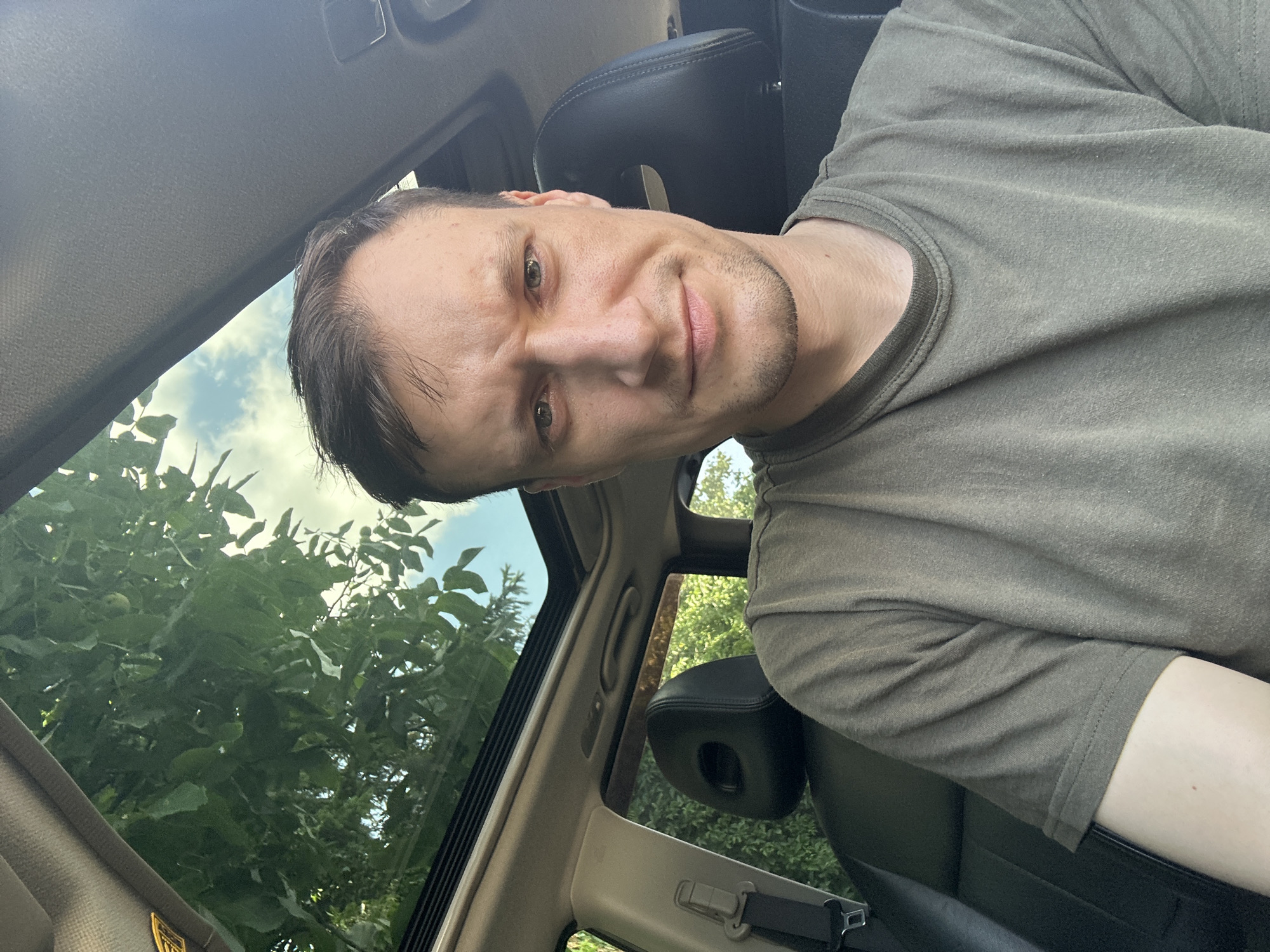 Parked car selfie session in Shatava, sunroof open, energy drink in hand