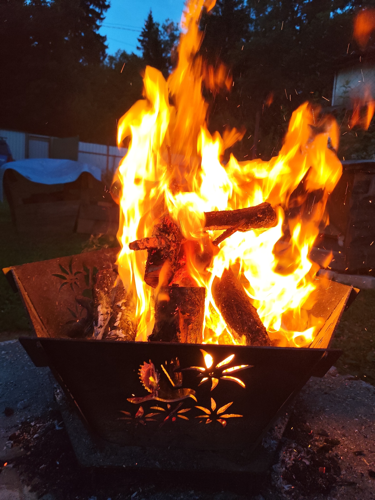 Decorative fire pit burning in a Kolpakovo backyard
