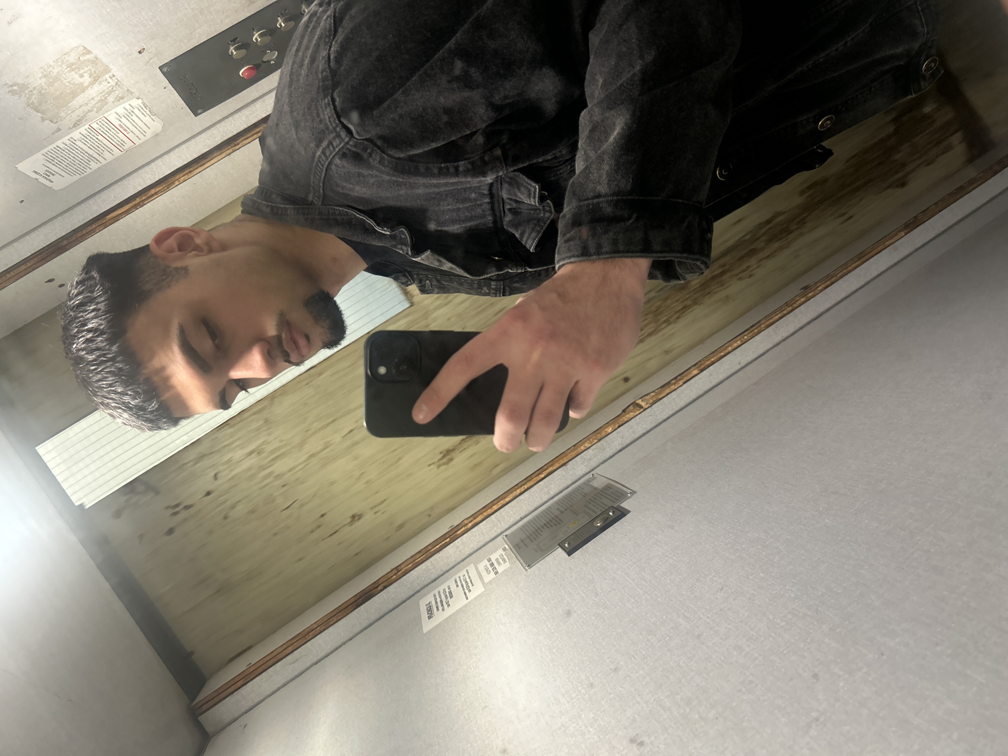 Man takes selfie in wood-paneled elevator in Sofia