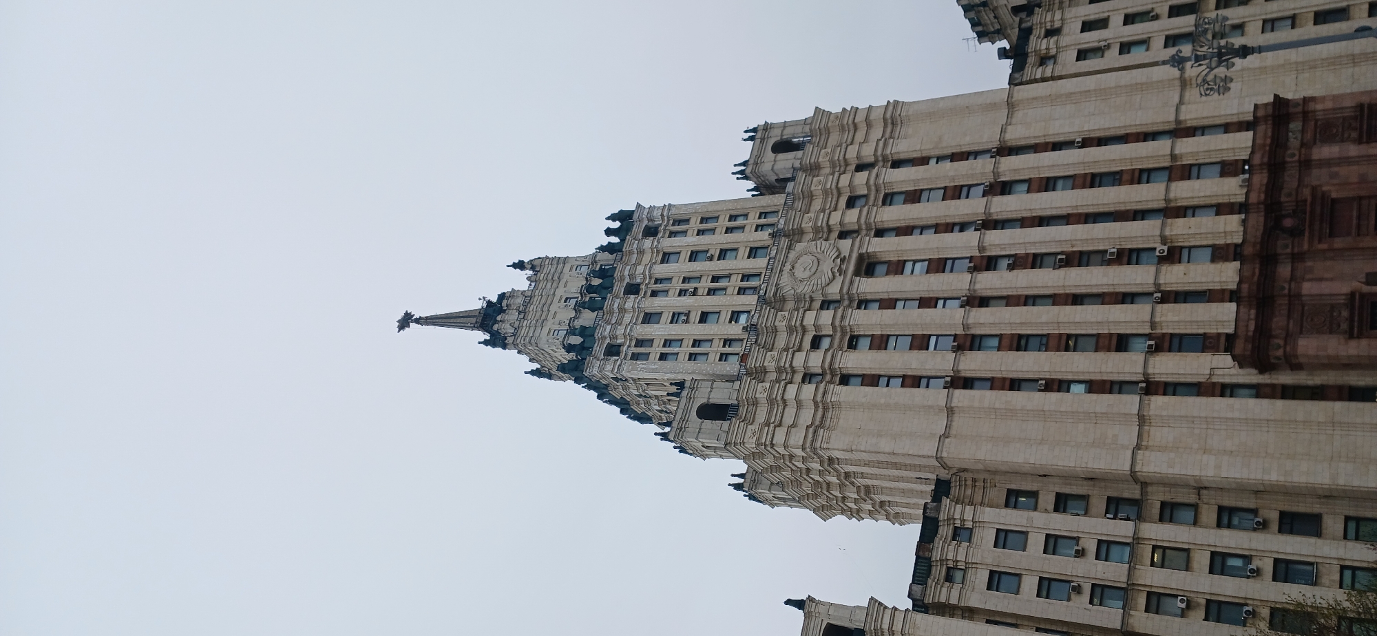 Urban moments captured: buildings, photographer, commuter with puzzle