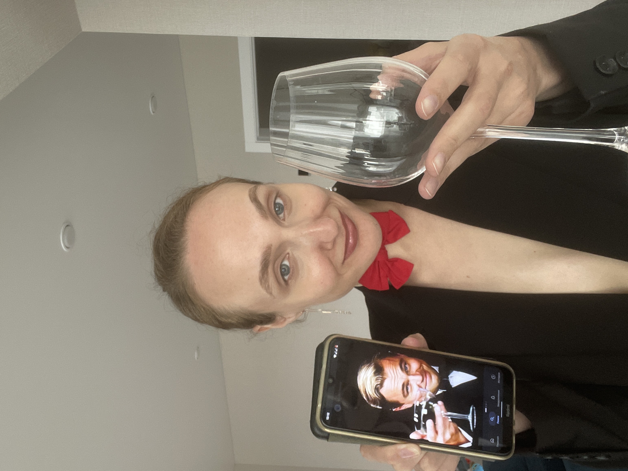 Woman mimics Leonardo DiCaprio with drawn mustache, wine glass pose