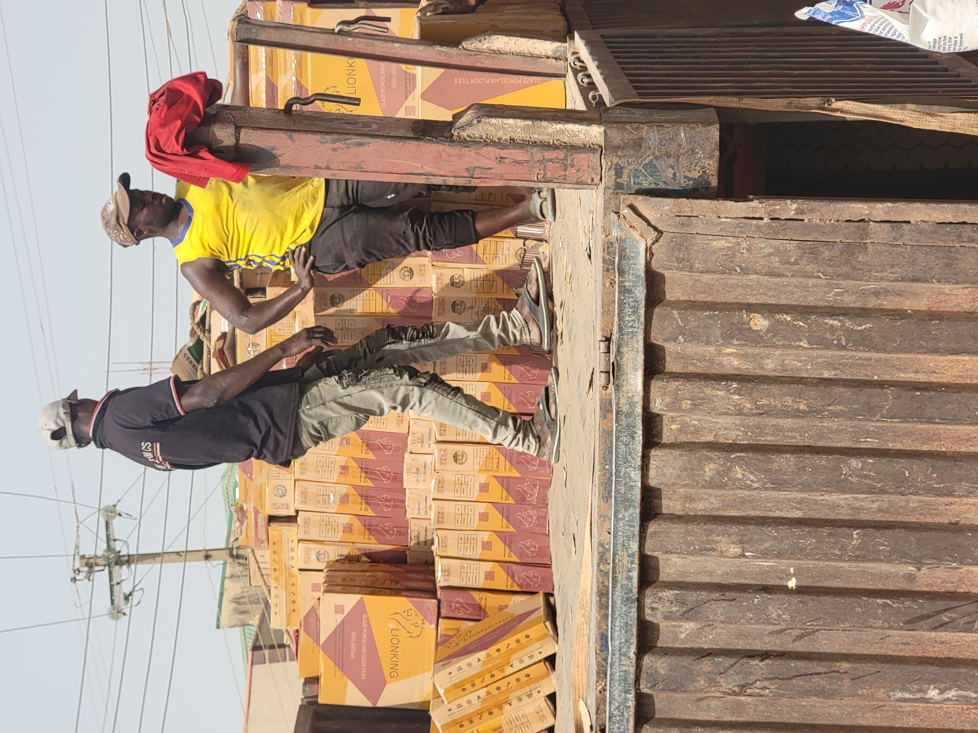 Man photographed outside building in Maiburiji, Nigeria