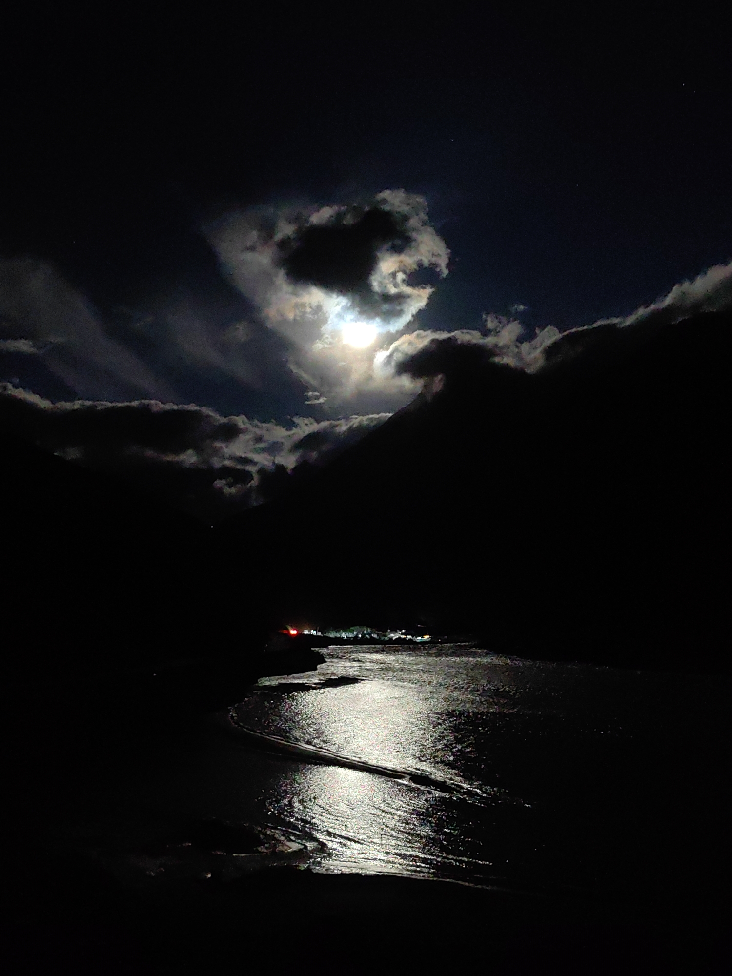 Moonlit water and cloud cover near Sissu, India