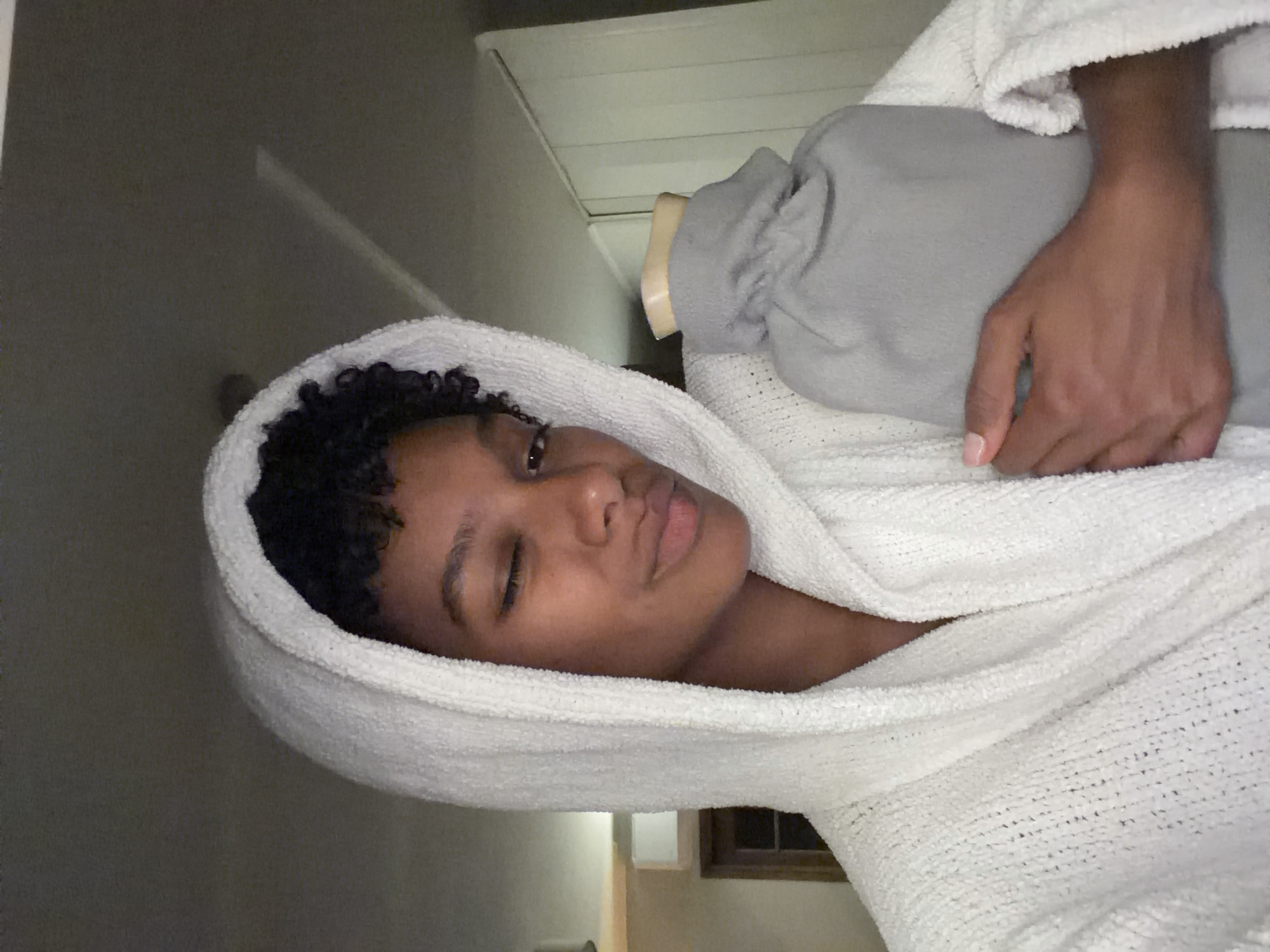 Person photographed in towel at Champs-sur-Marne residence