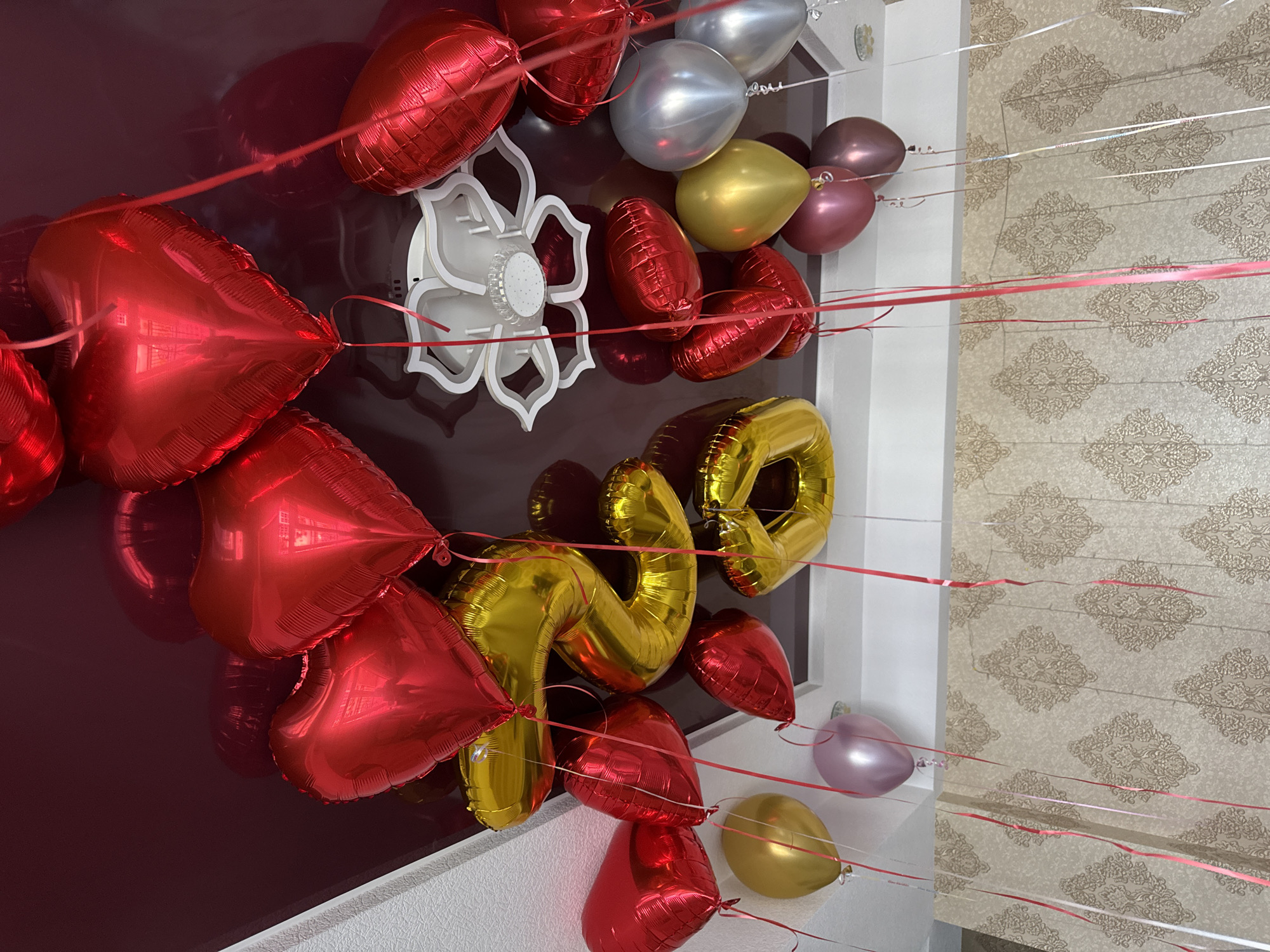 Balloons and red roses mark a festive celebration setup