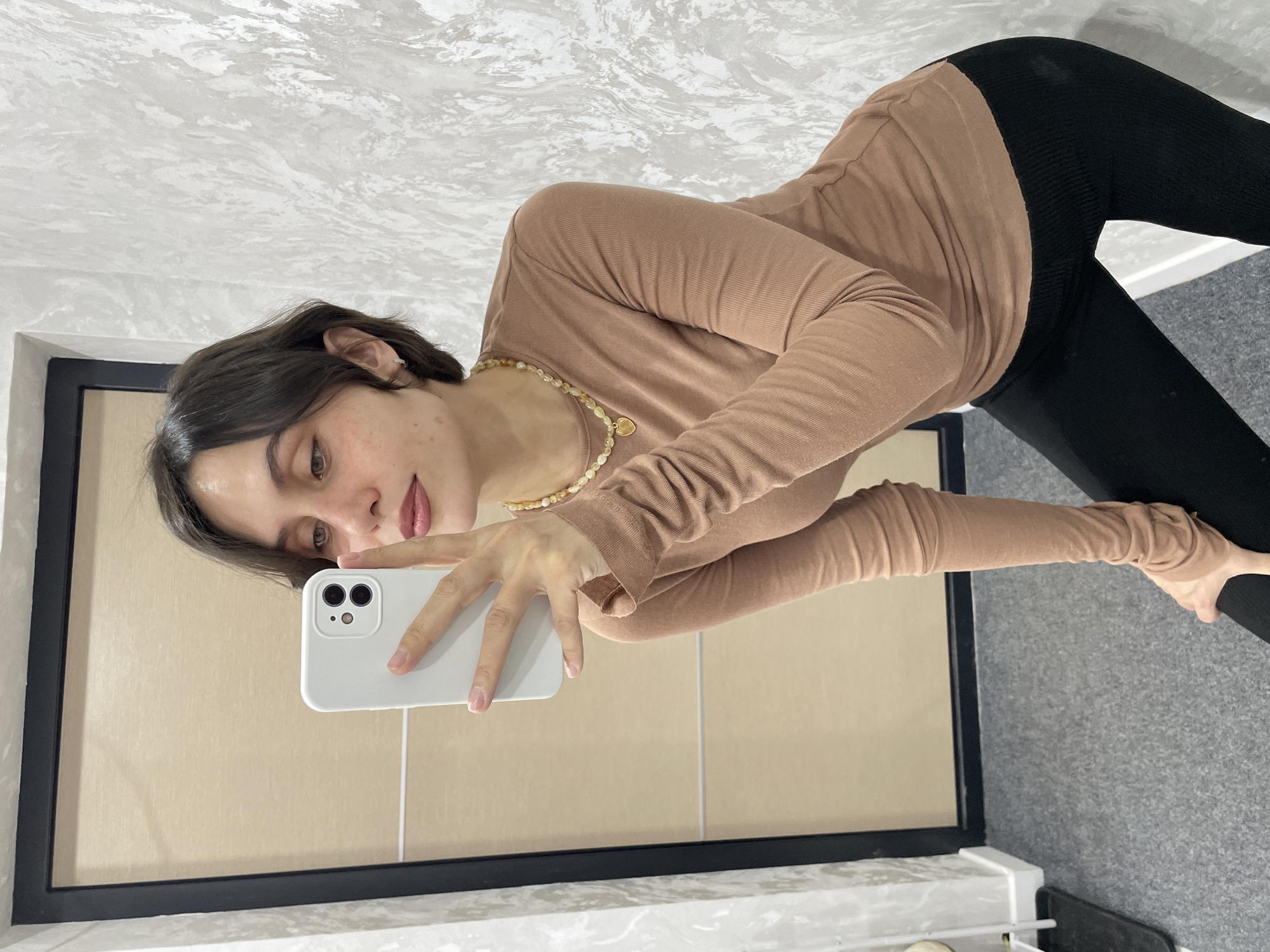 Woman takes mirror selfie in Izhevsk early morning