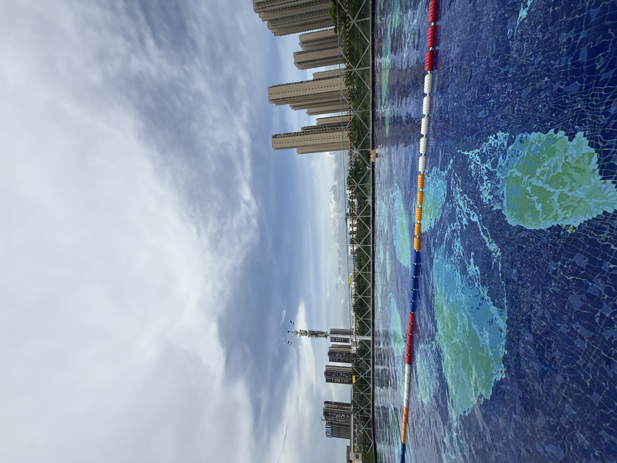 Rooftop pool session above Huizhou's urban skyline
