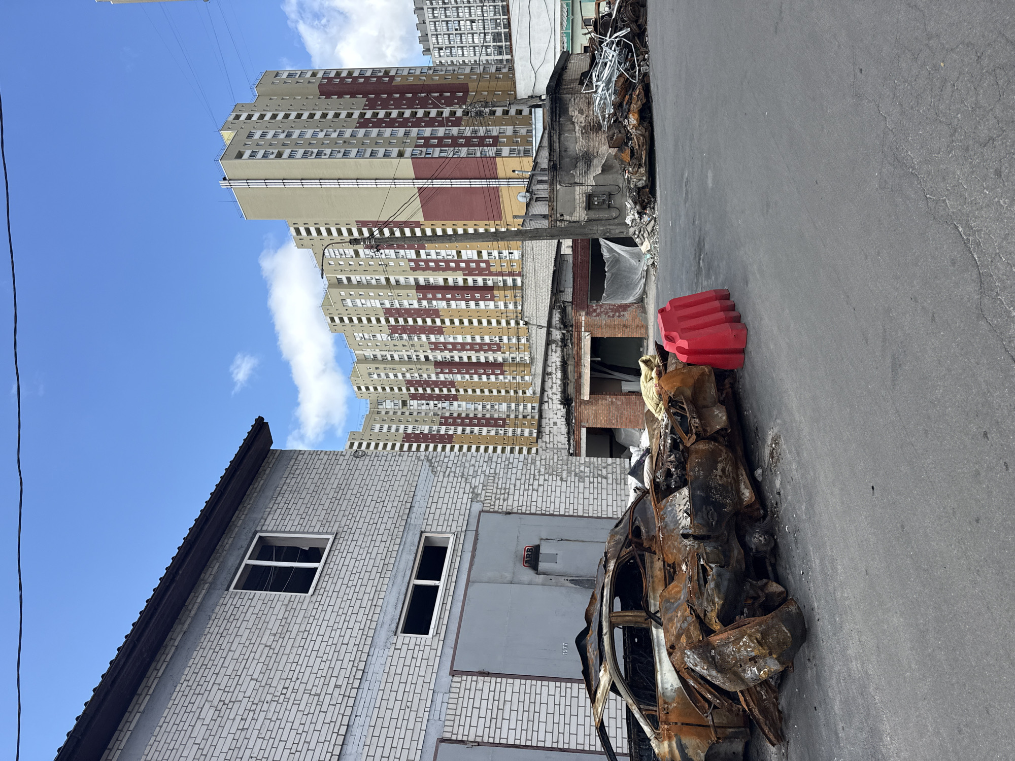 Burnt vehicles and damaged garages near Kyiv residential building