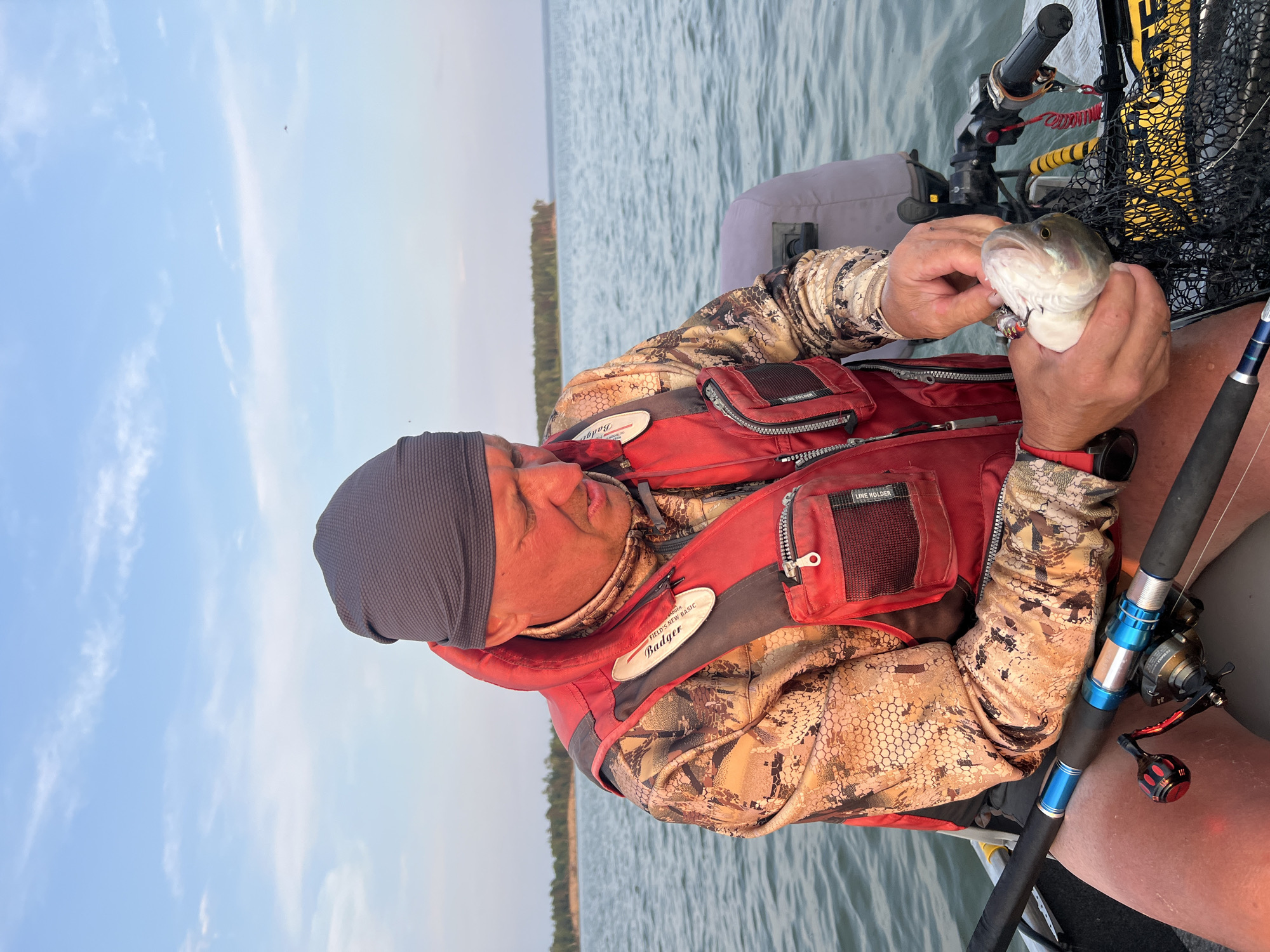 Fishing on the water near Borovoe, fresh catch in hand.