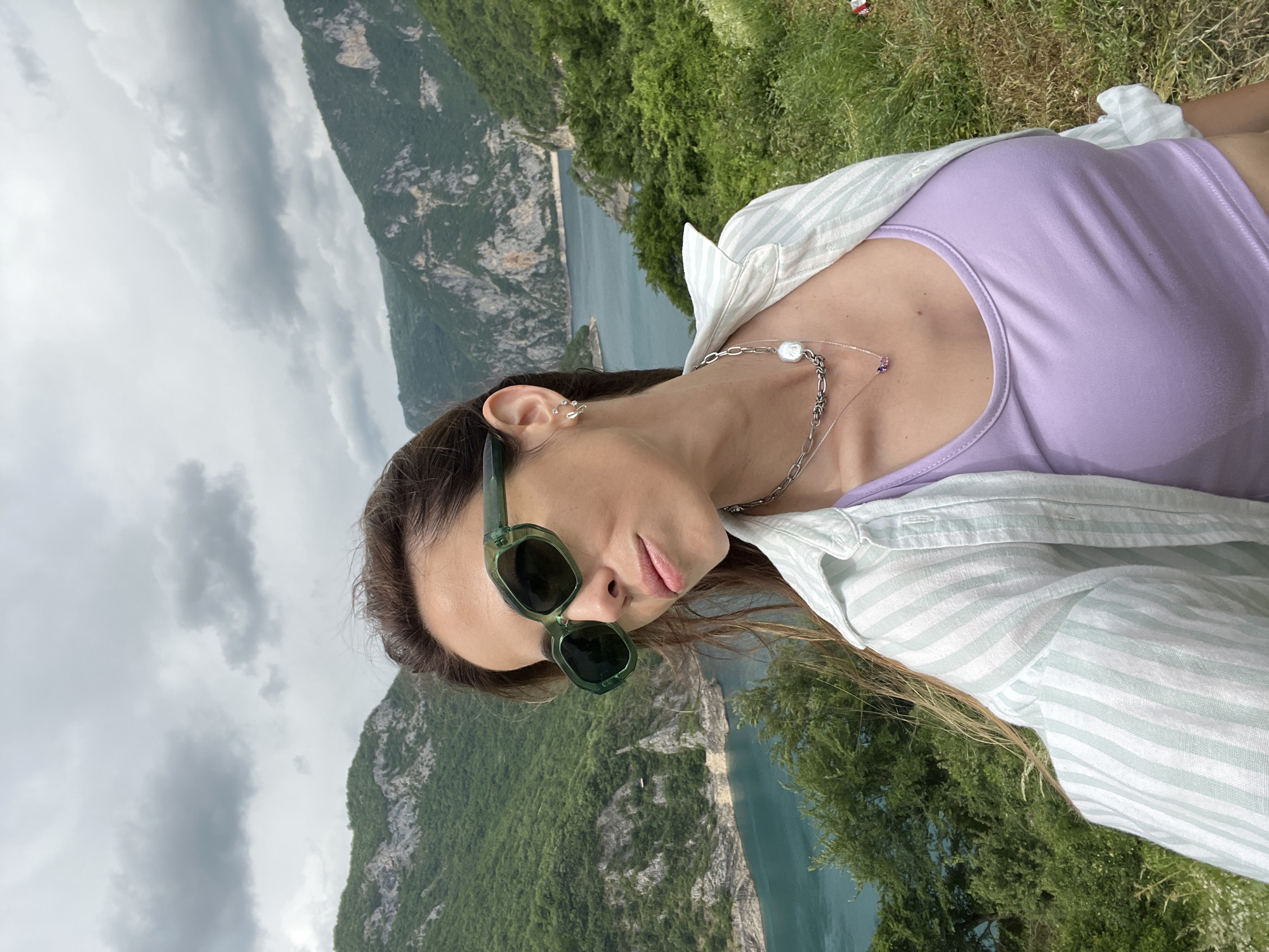 Woman photographs scenic mountain lake vista in Plužine, Montenegro