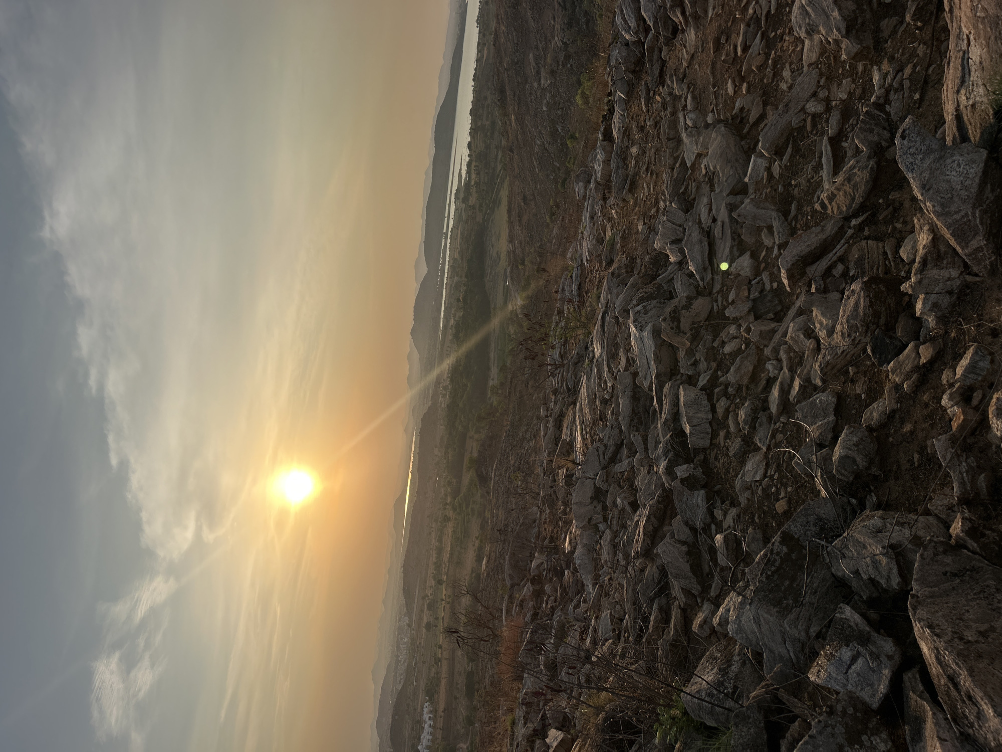 Sunset landscape captured over mountains and water in Puttaparthi