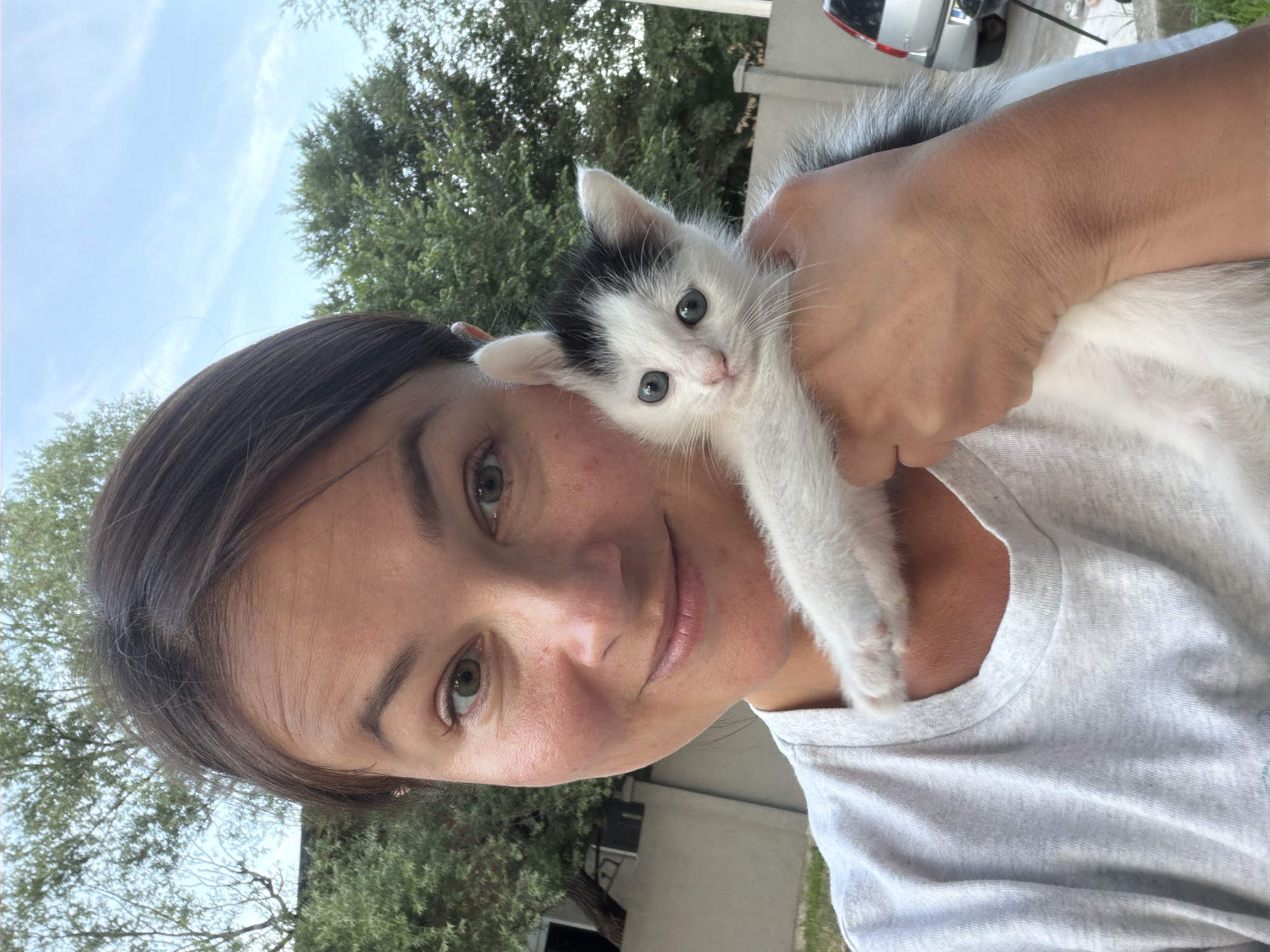 Woman with kitten amid construction scenes in Montenegro