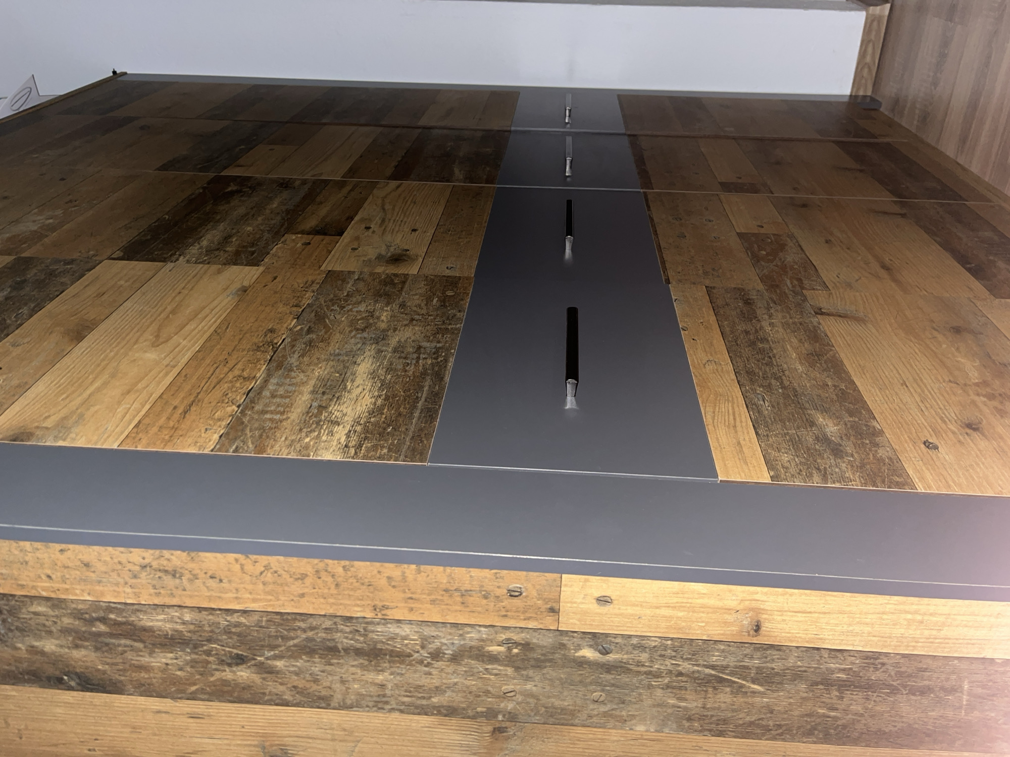 Close-up documentation of wooden surface with metal fixture captured