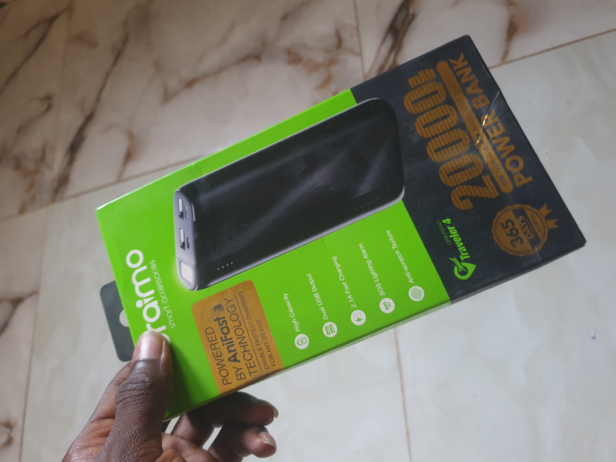 Consumer unboxes smartphone accessories and household products indoors