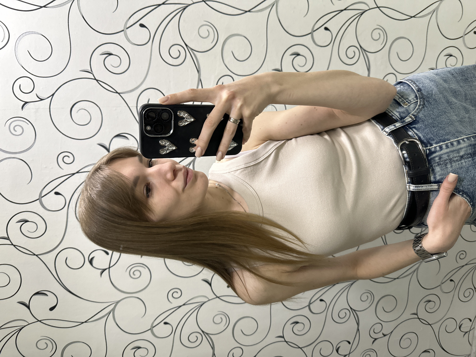 Woman takes selfie with decorated phone in Chaikovsky, Russia
