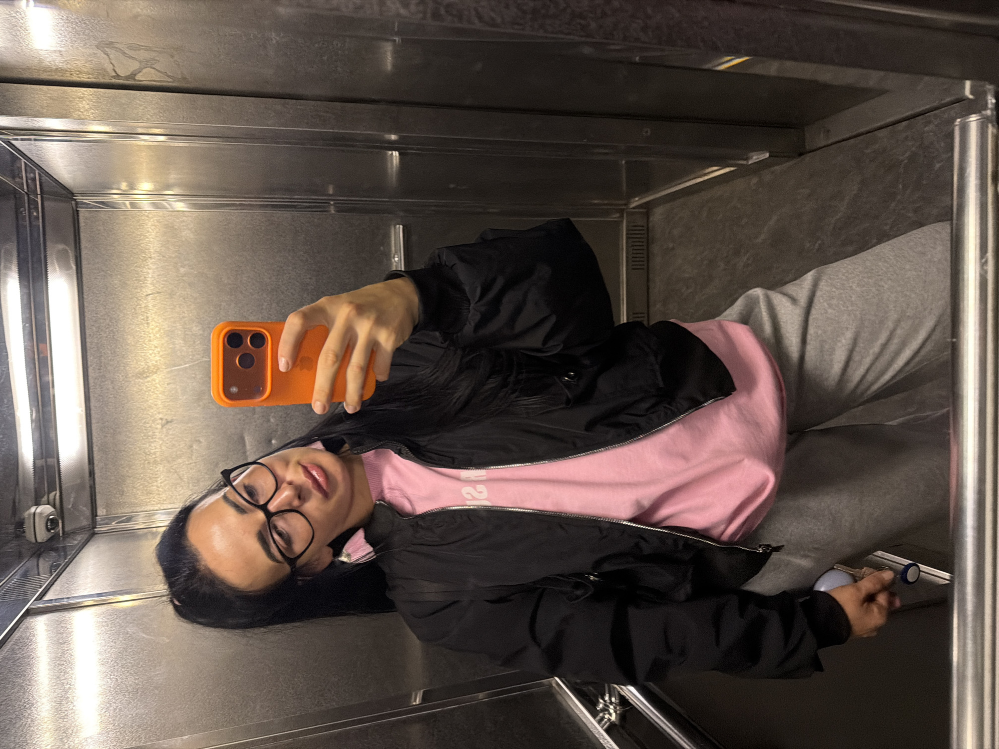 Woman takes selfies, disposes items in Saint Petersburg elevator area