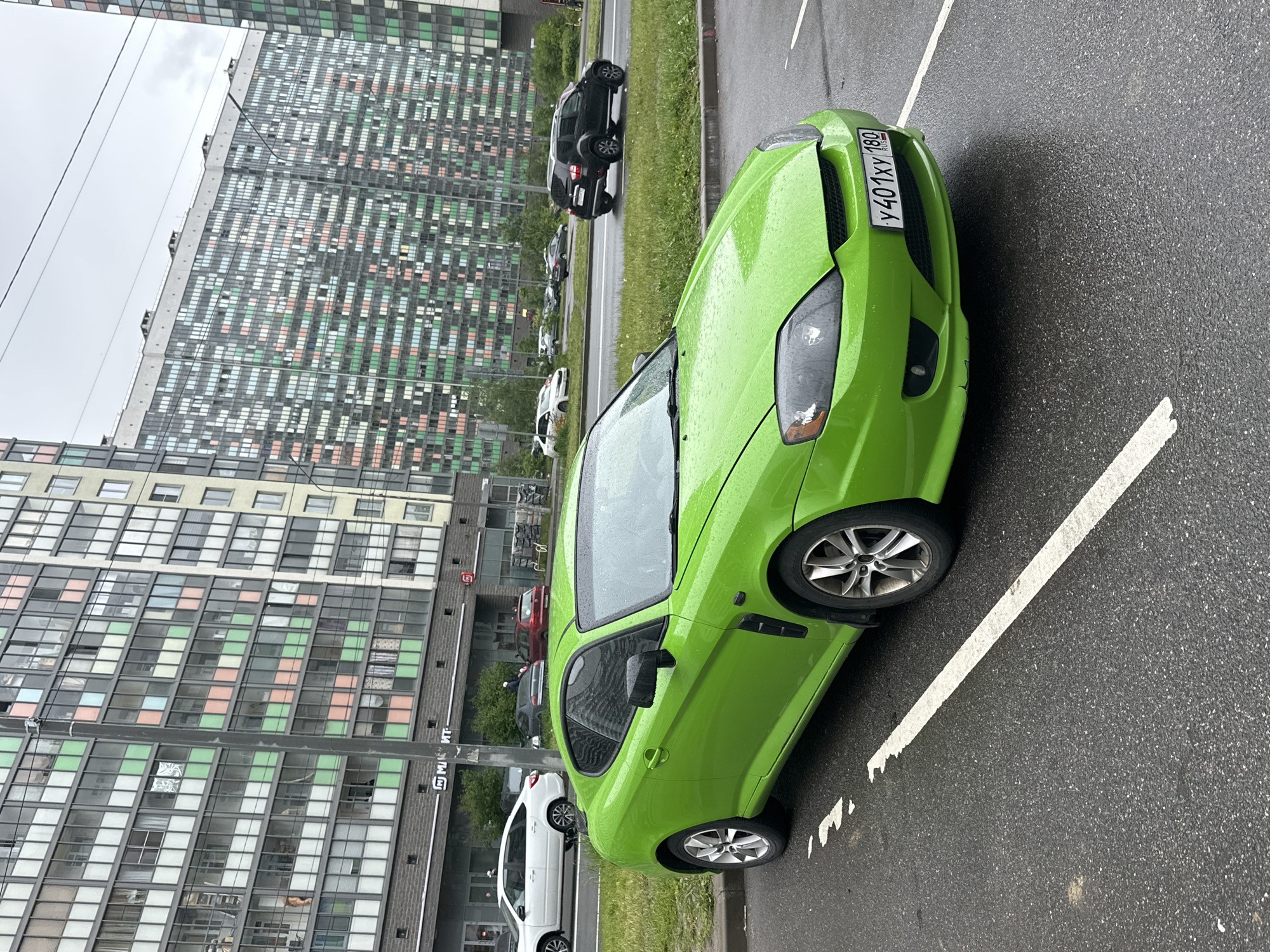 Vehicles parked on wet streets in Murino, Russia