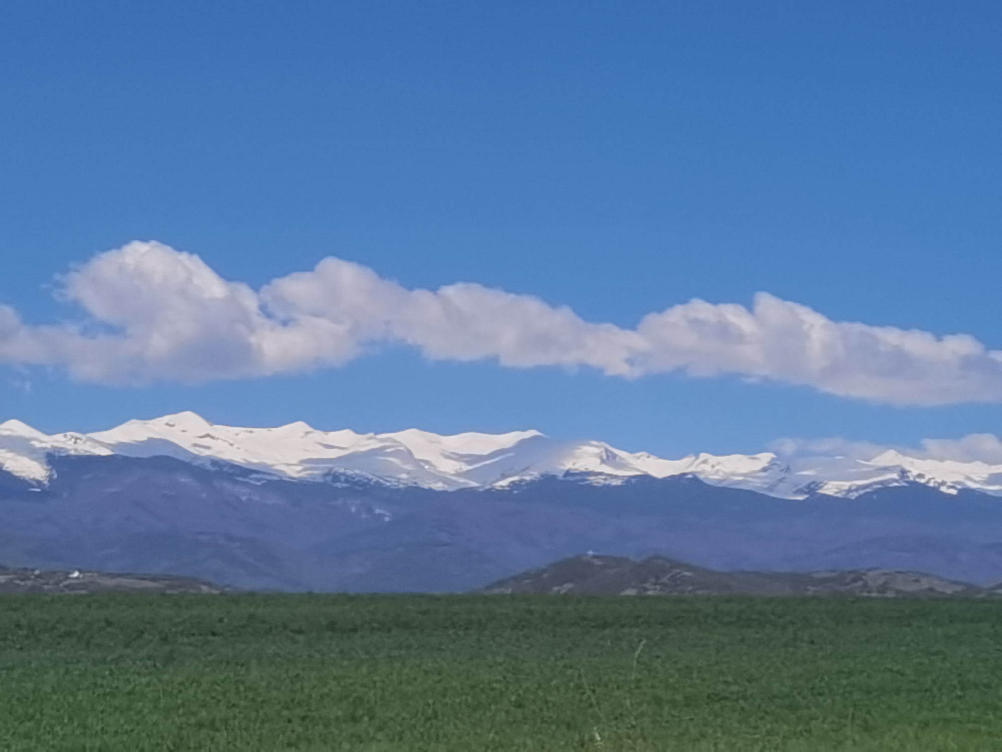 Rural Bulgaria landscape with snow-capped mountains documented