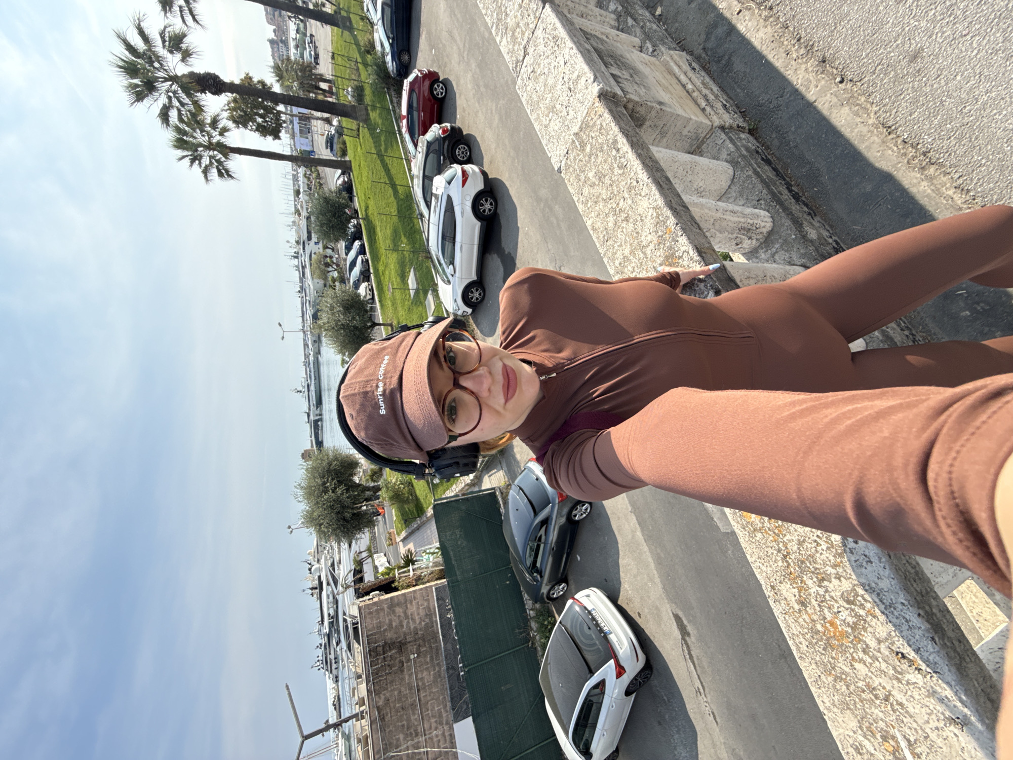 Woman in brown athletic wear photographed on Sanremo steps