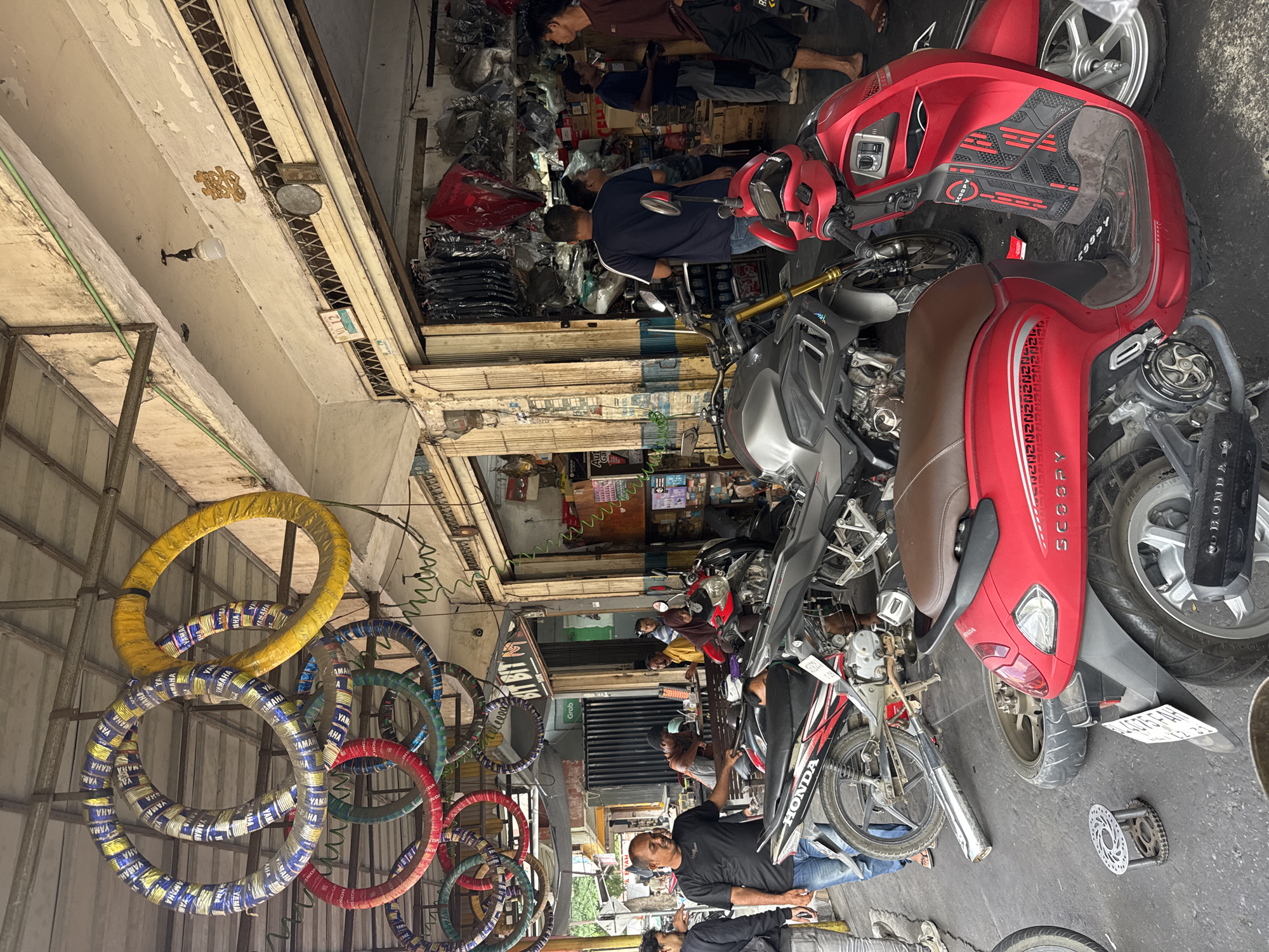 Inside a busy motorcycle repair shop in Banda Aceh