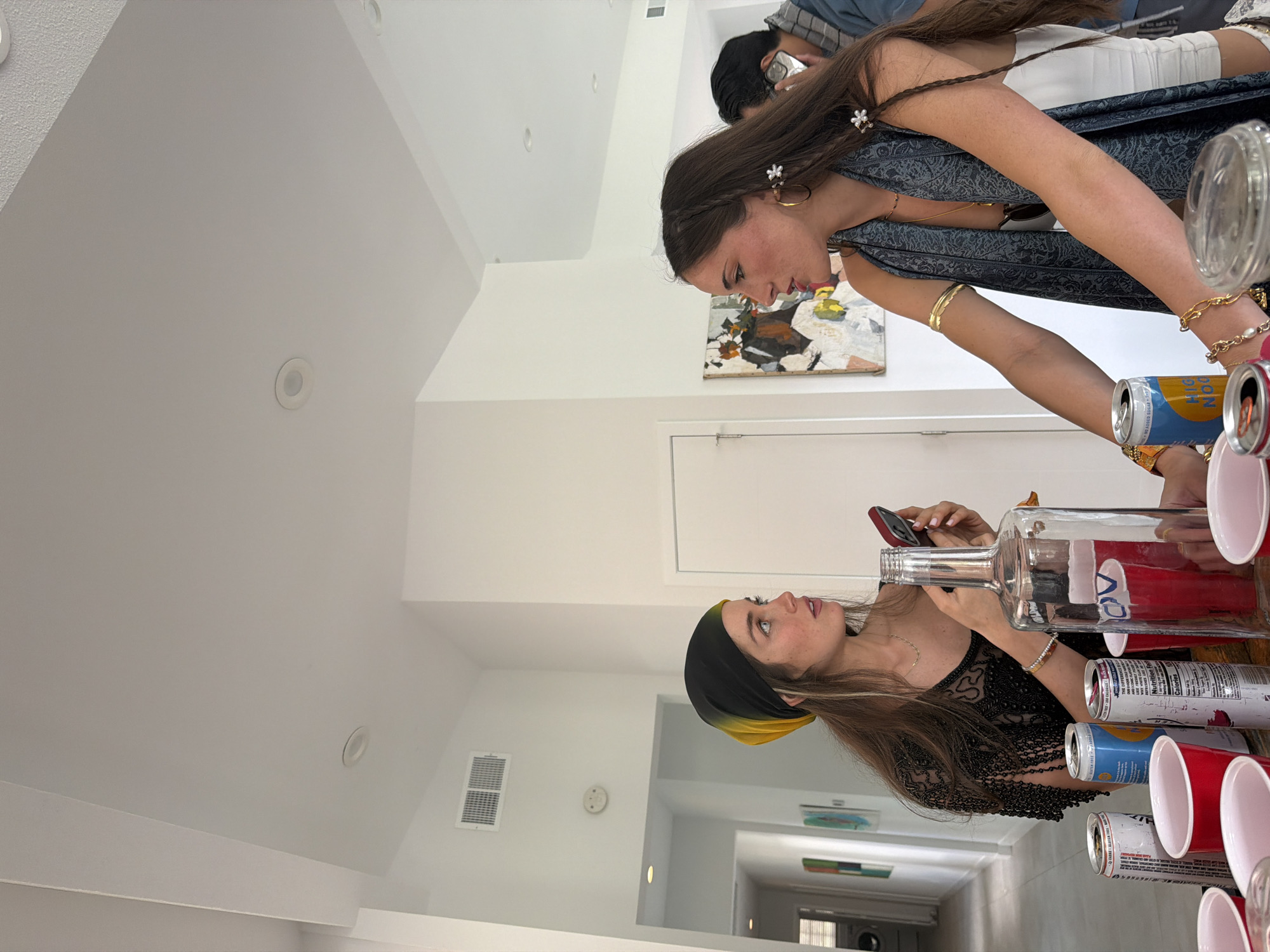 Women pour drinks at indoor gathering in La Quinta