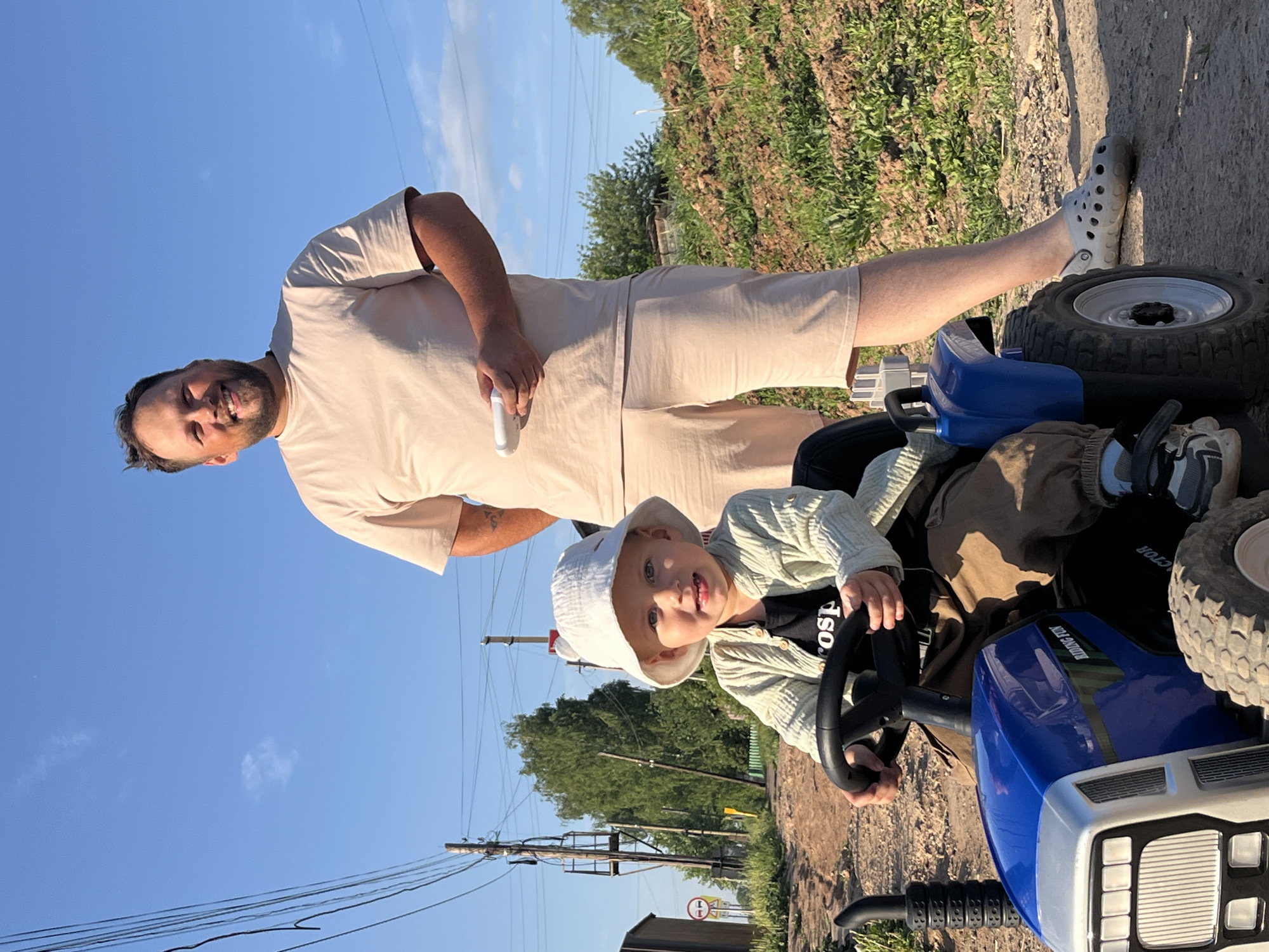 Family enjoys toy tractor playtime in rural Russia