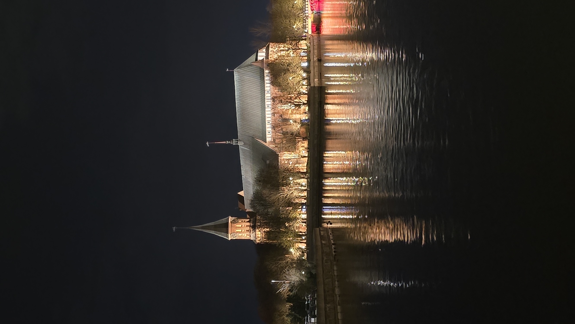 Kaliningrad Cathedral photographed at night reflecting in Pregel River