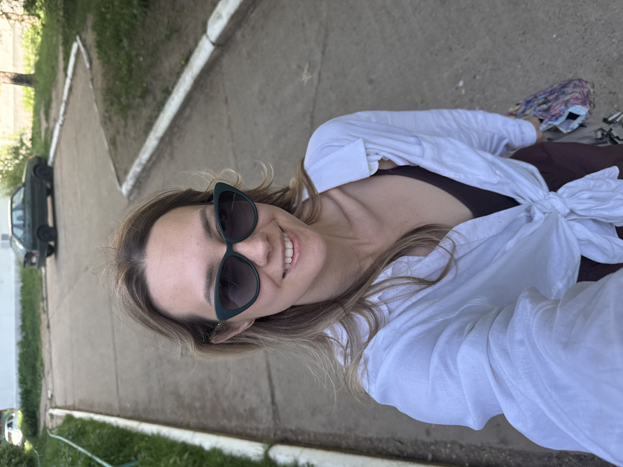Woman takes selfie on sidewalk in Chaikovsky, Russia