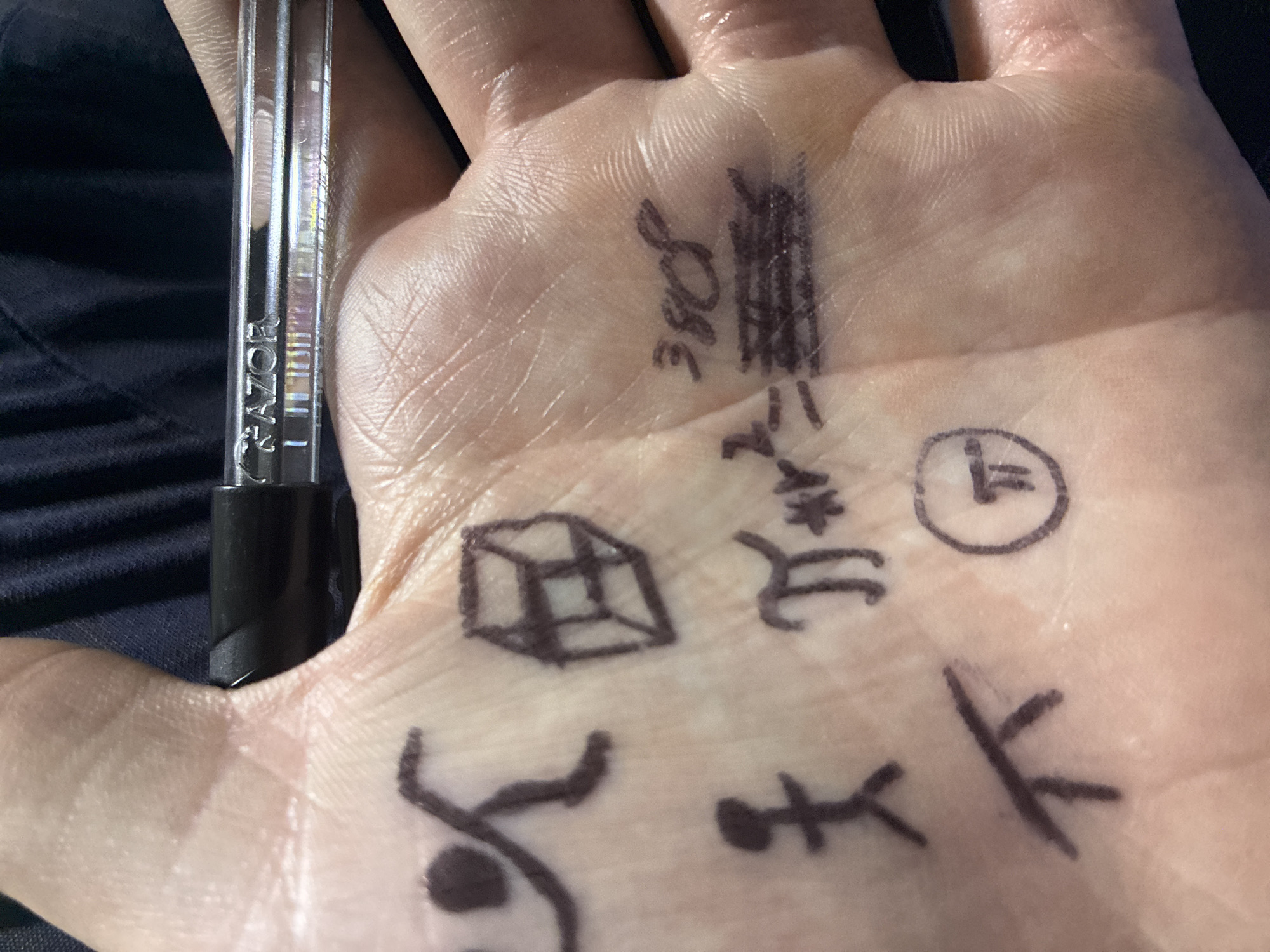 Person draws on palm during warehouse meeting in Mexico