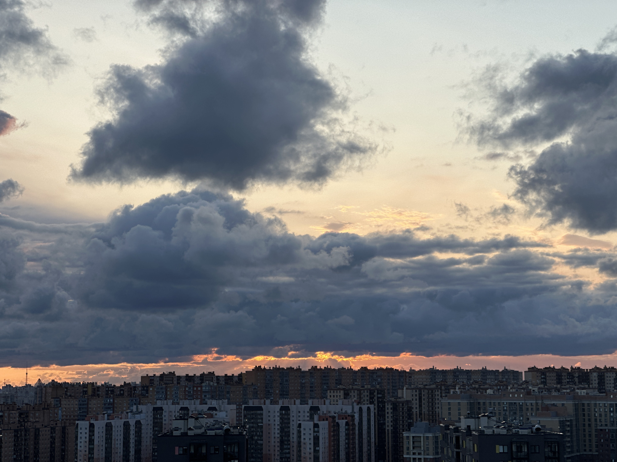 Kudrovo's high-rise skyline under a stormy dusk sky