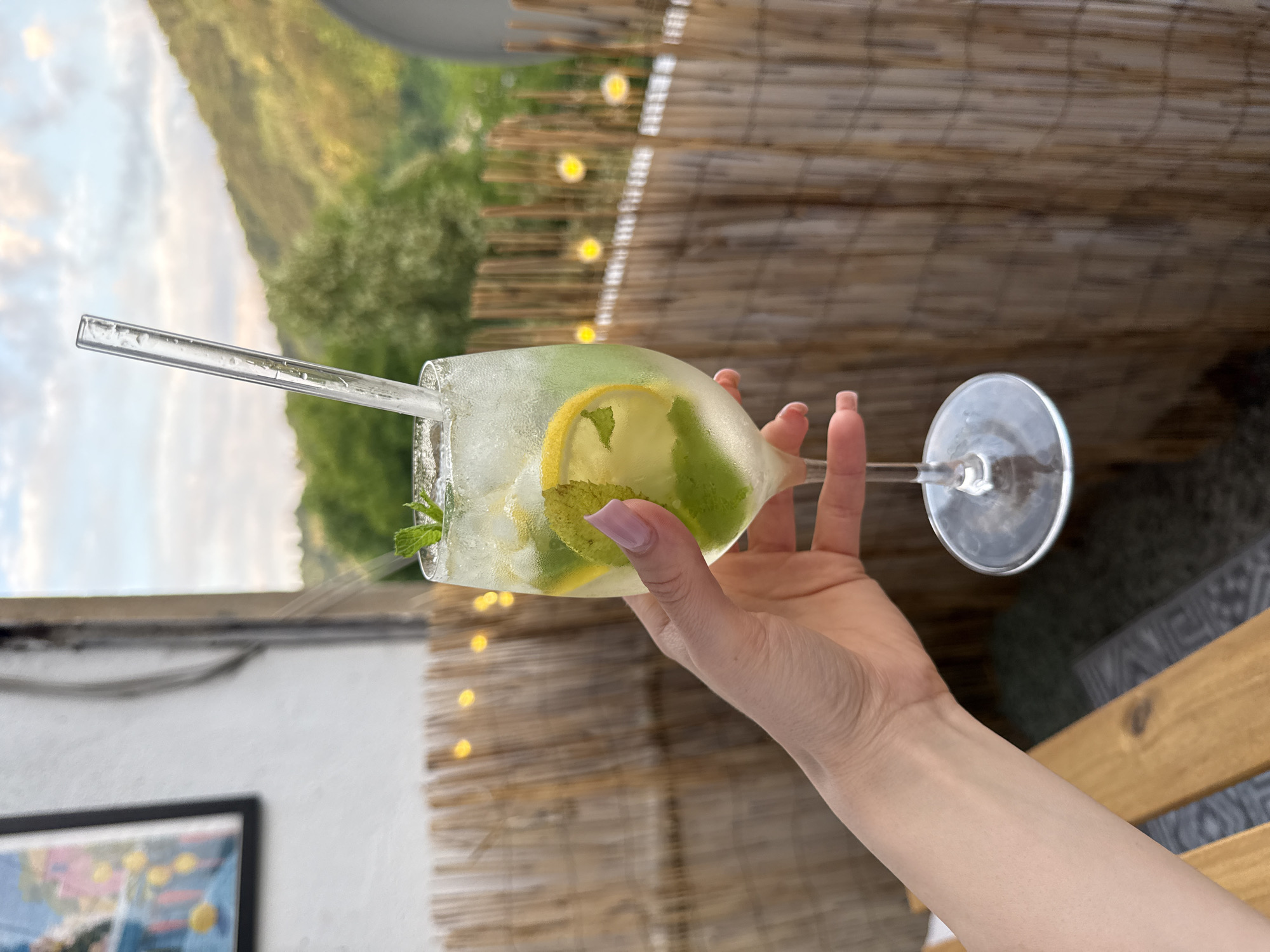 Iced lemon mint drink, held close, two angles