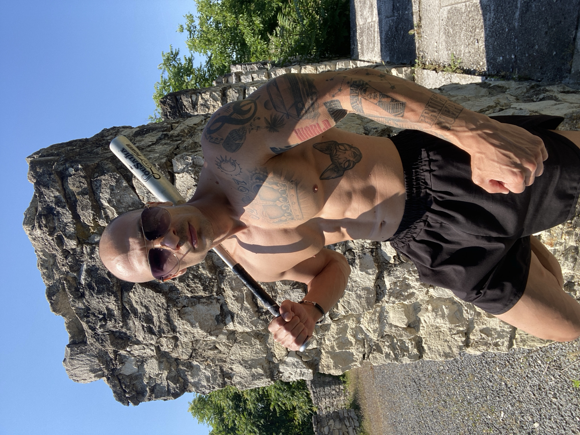 Tattooed man performs athletic stunts at Bulgarian ruins