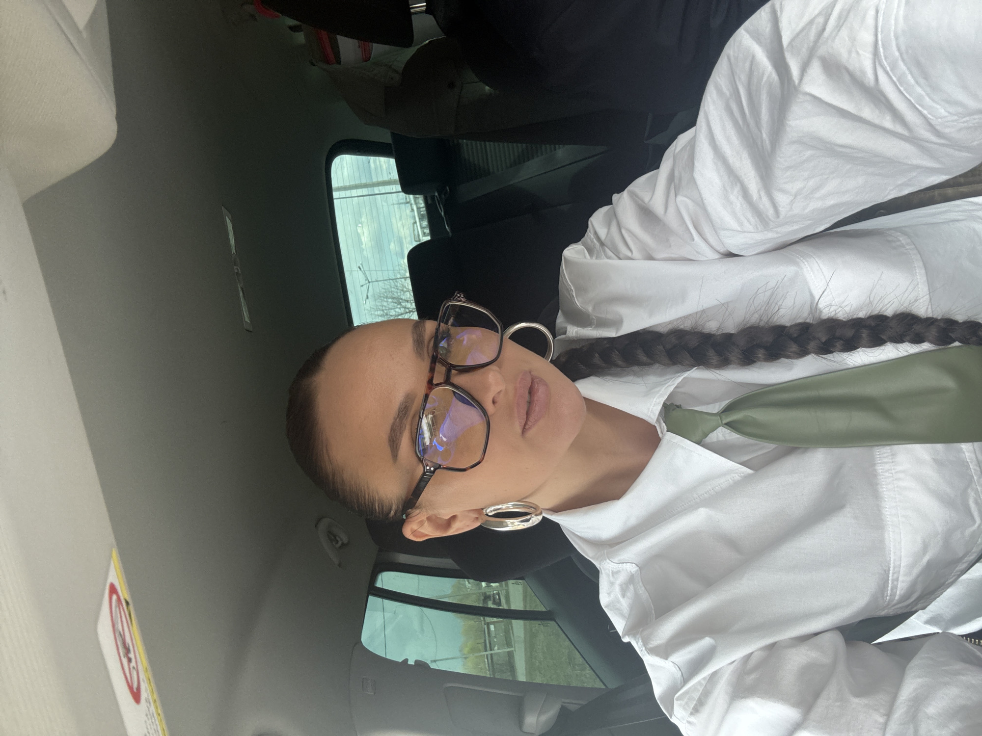 Woman takes car selfie in white shirt, Chaikovsky