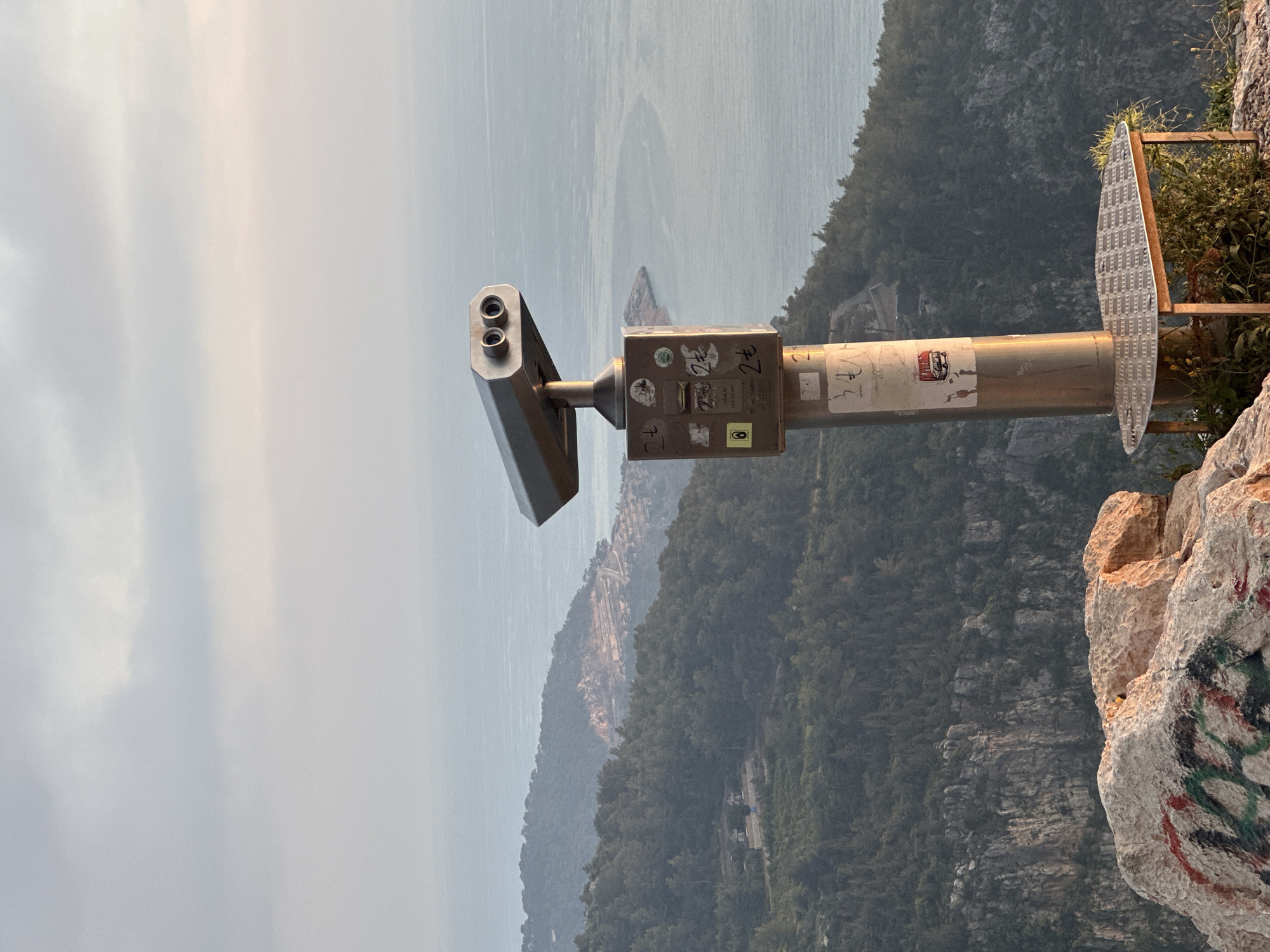 Tourist captures scenic overlook with binoculars in Fethiye