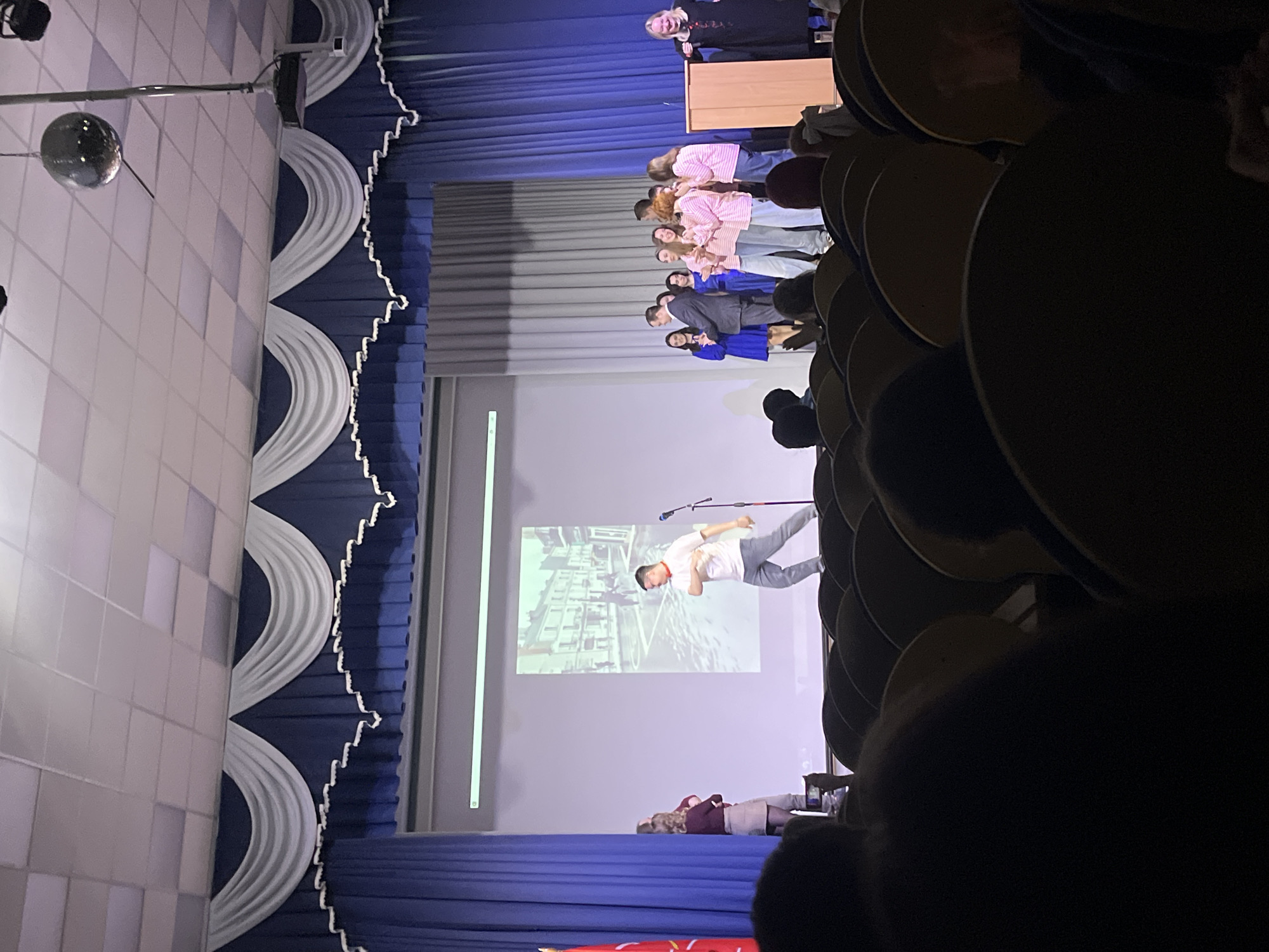 Presentation ceremony held at Vsevolozhsk auditorium with speakers and slideshow
